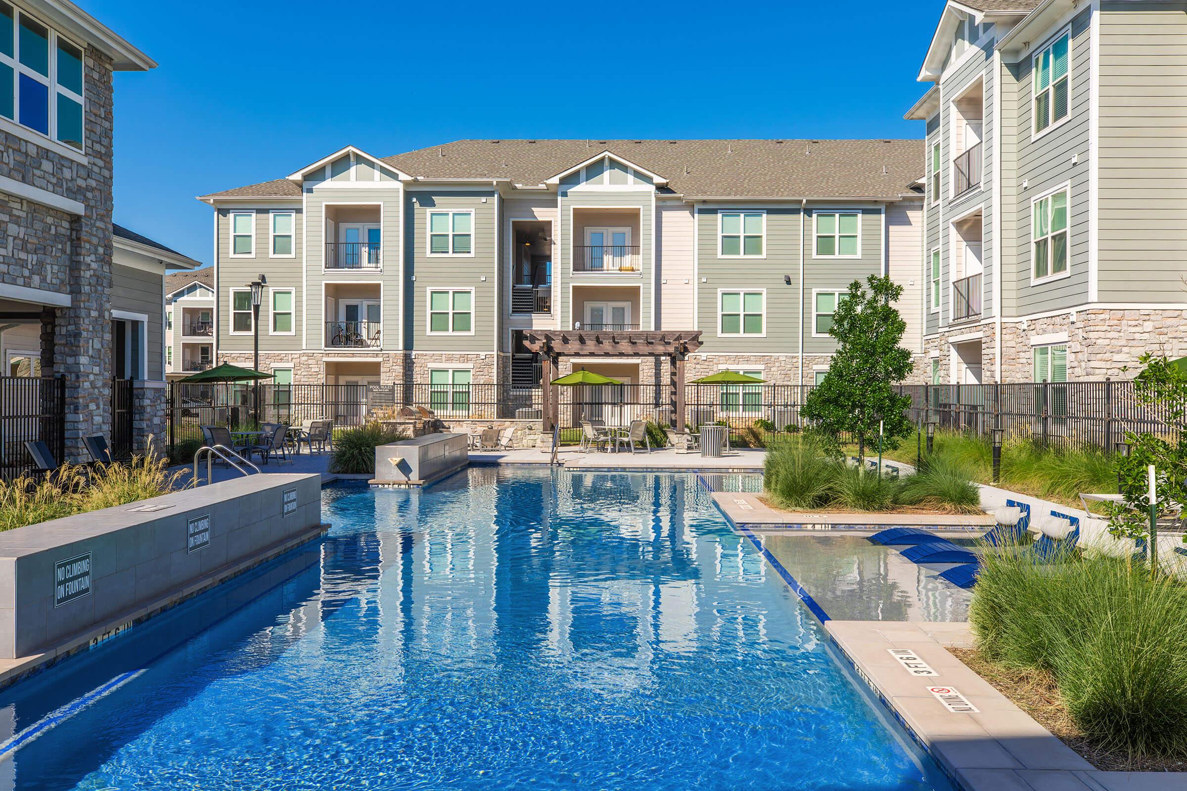 a person in a pool of water in front of a building