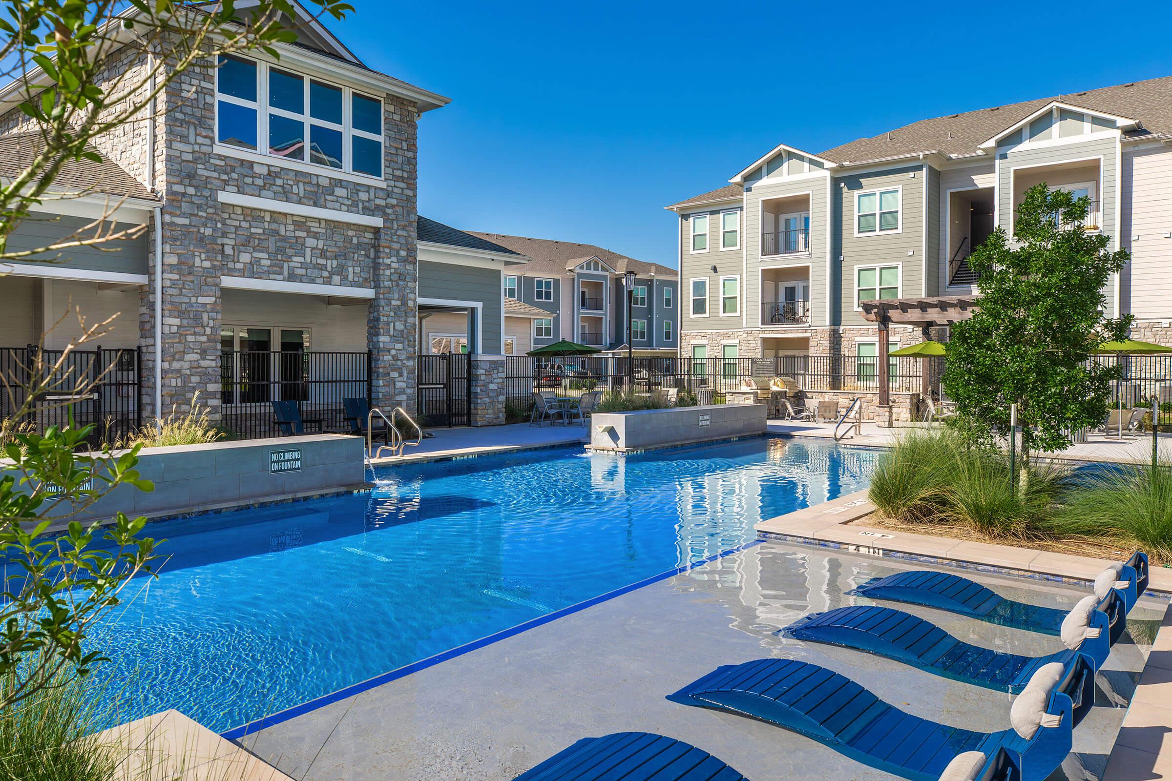 a house with a pool in front of a building