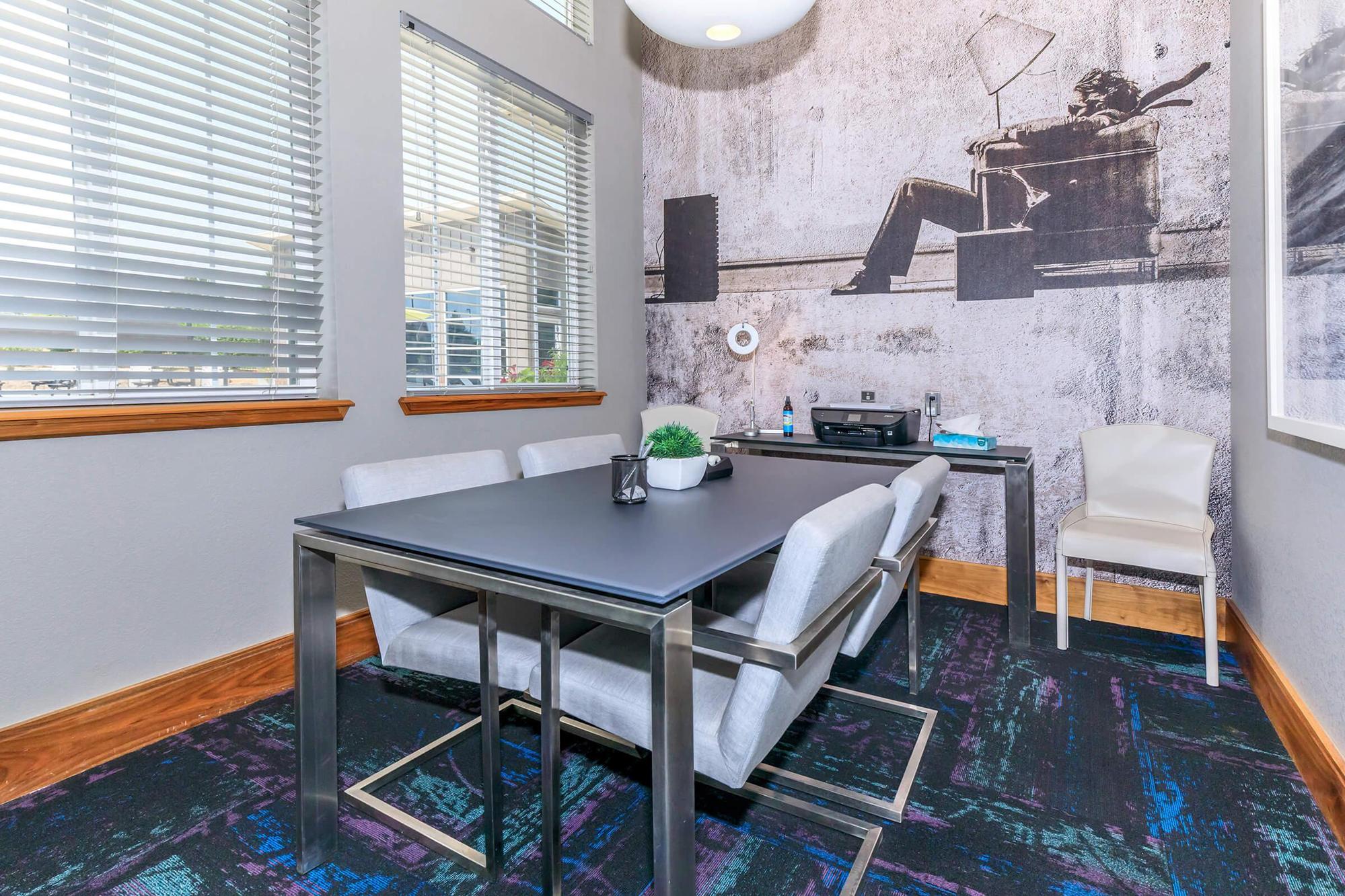 a kitchen with a table in front of a window