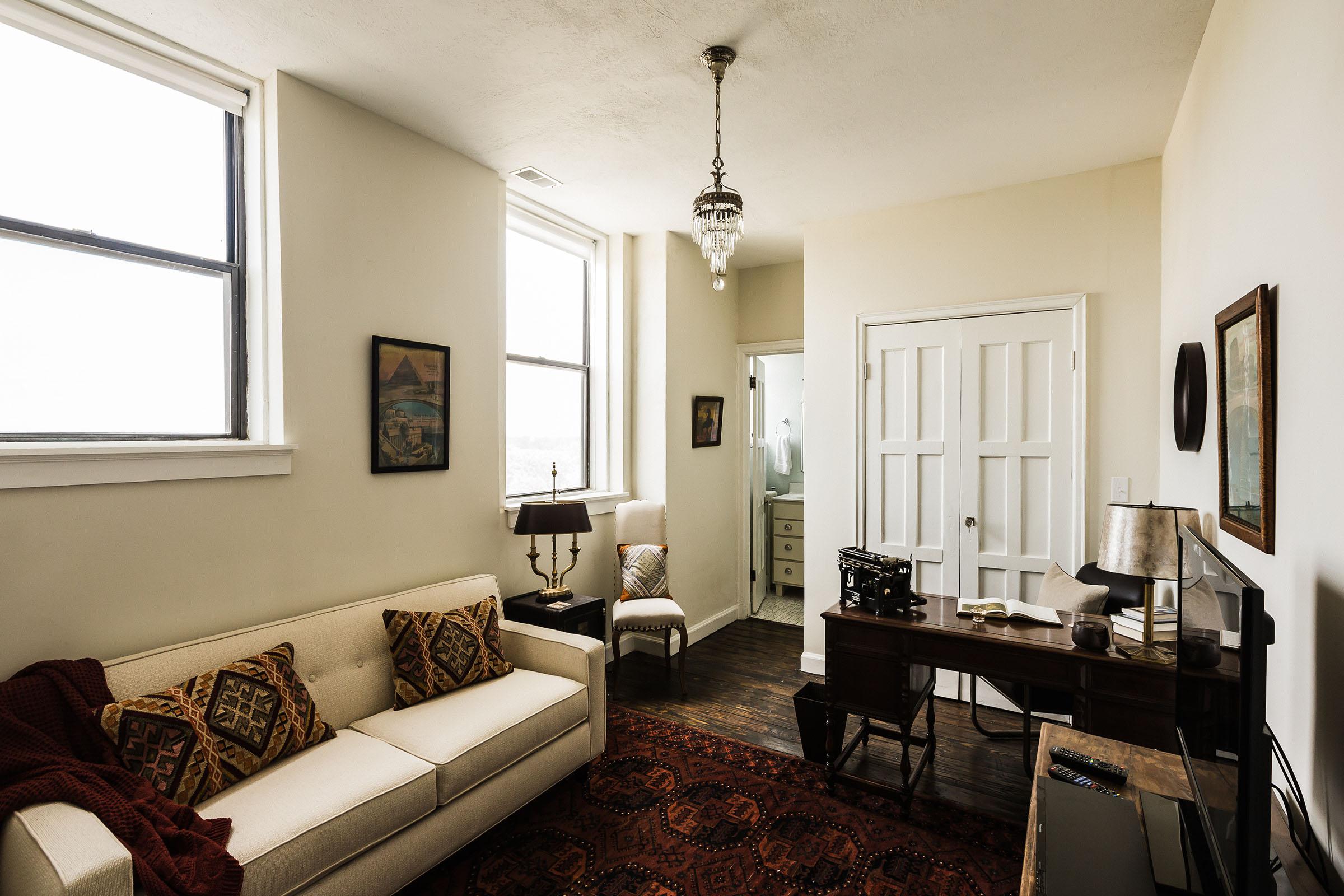 a living room filled with furniture and a large window