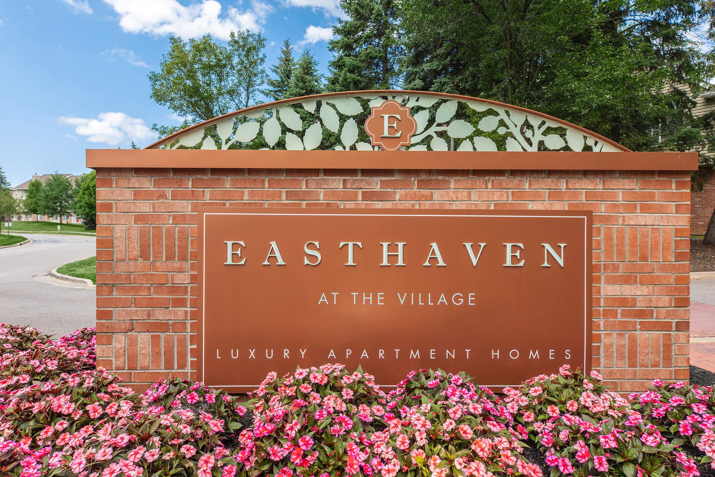 a close up of a flower garden in front of a building