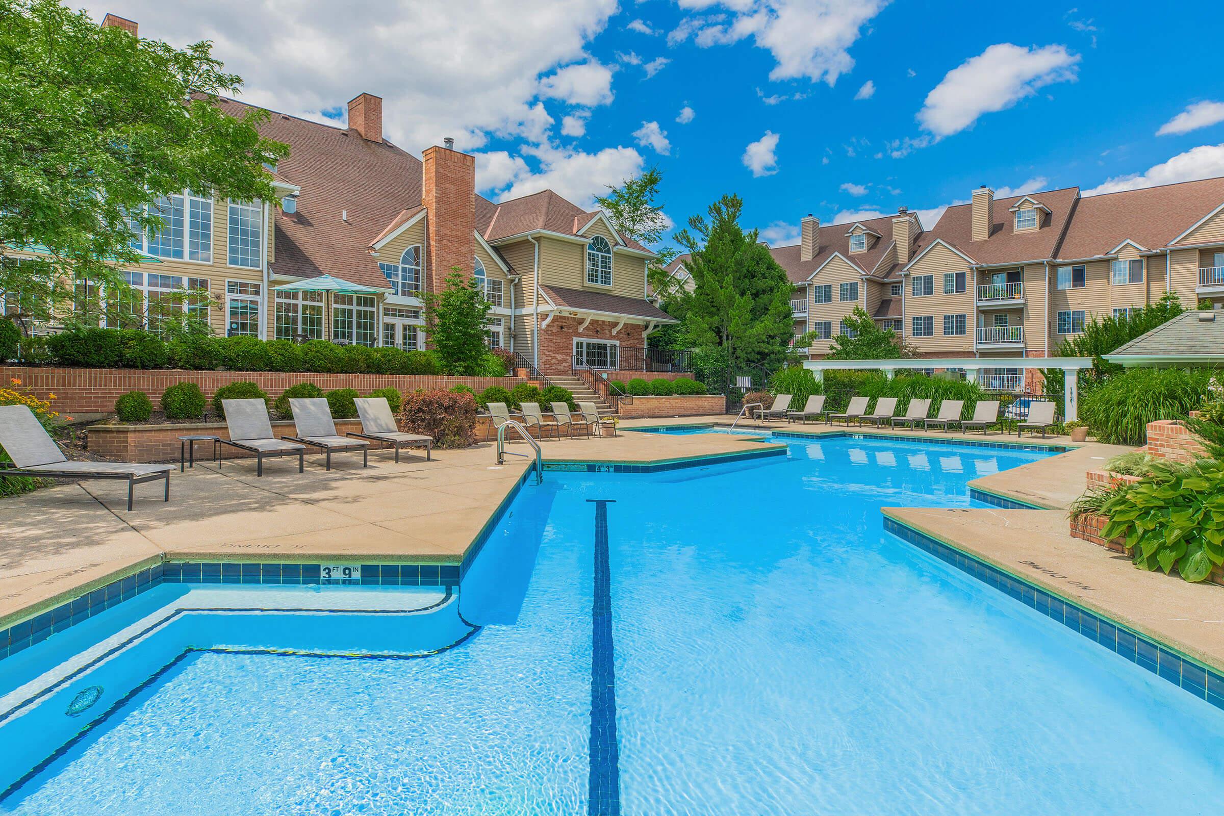 a house with a pool in front of a building