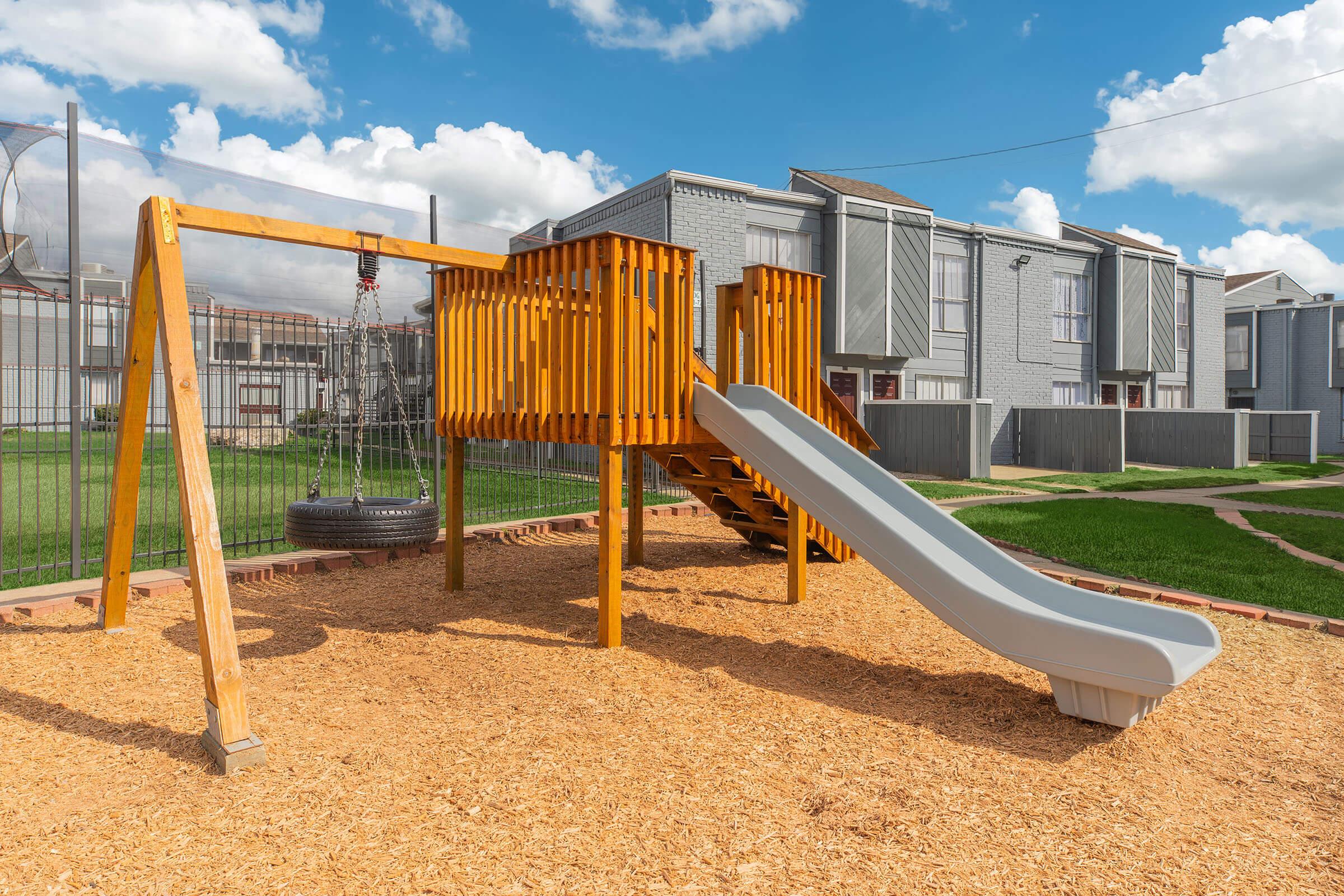 a playground in front of a fence