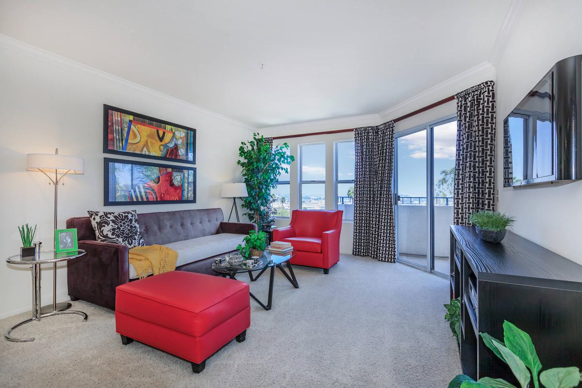 a living room filled with furniture and a large window