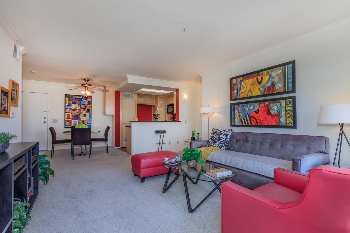 a living room filled with furniture and a red chair