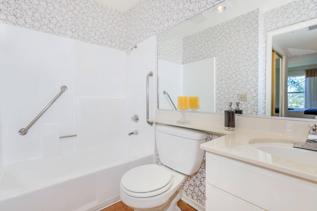 a large white tub sitting next to a sink