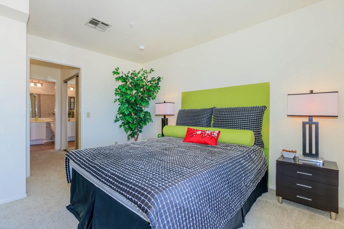 a living room filled with furniture and a bed