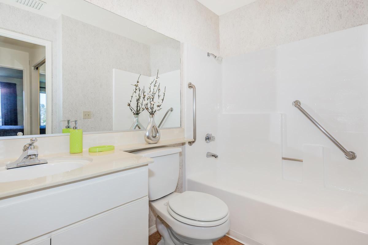 a white tub sitting next to a sink