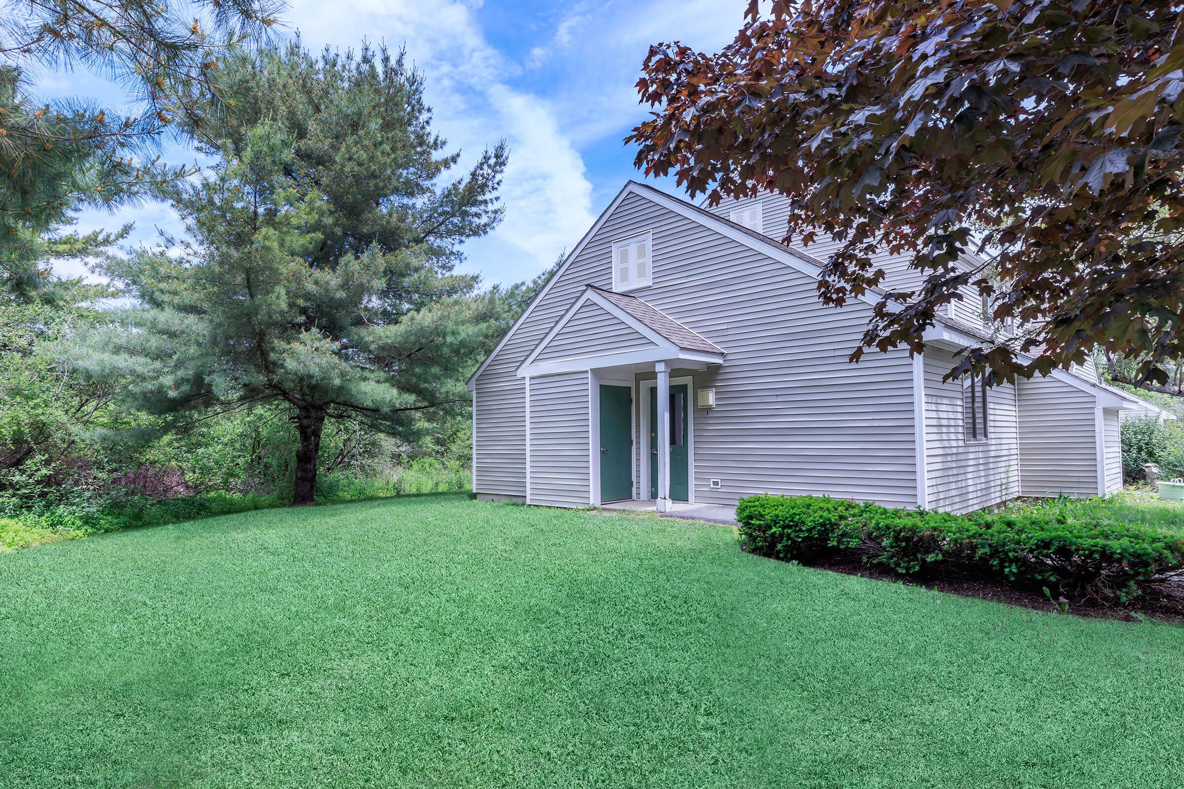 a green lawn in front of a house