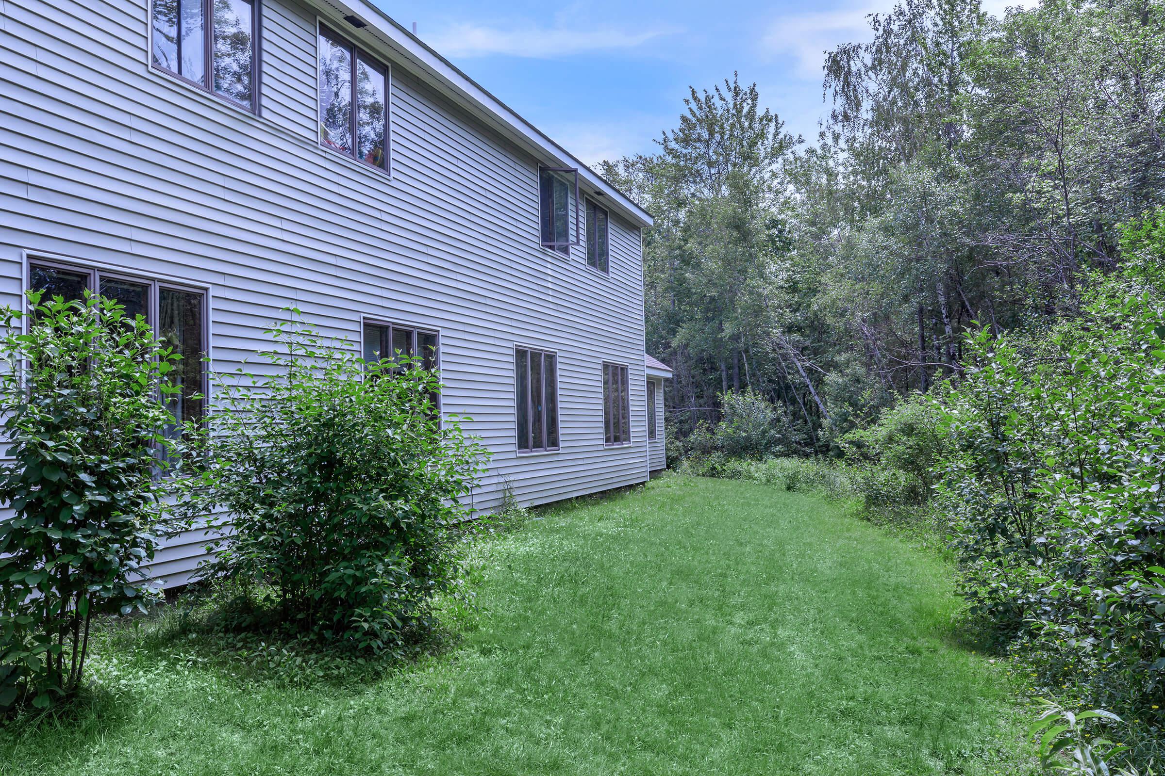 a house with bushes in front of a building