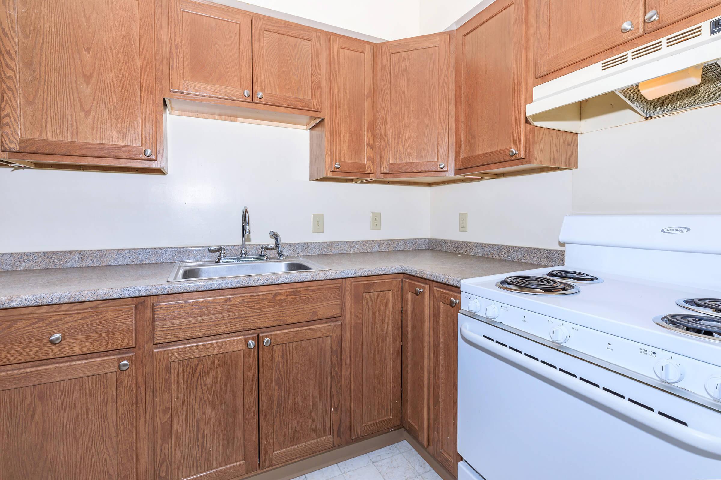 a kitchen with wooden cabinets