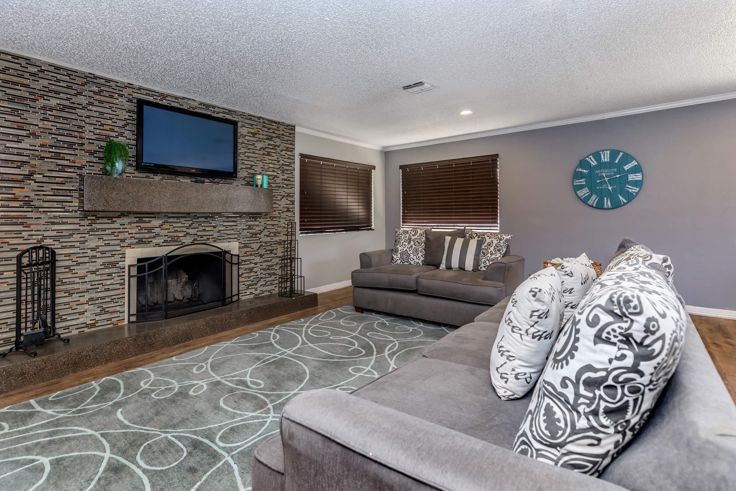 a living room filled with furniture and a fire place