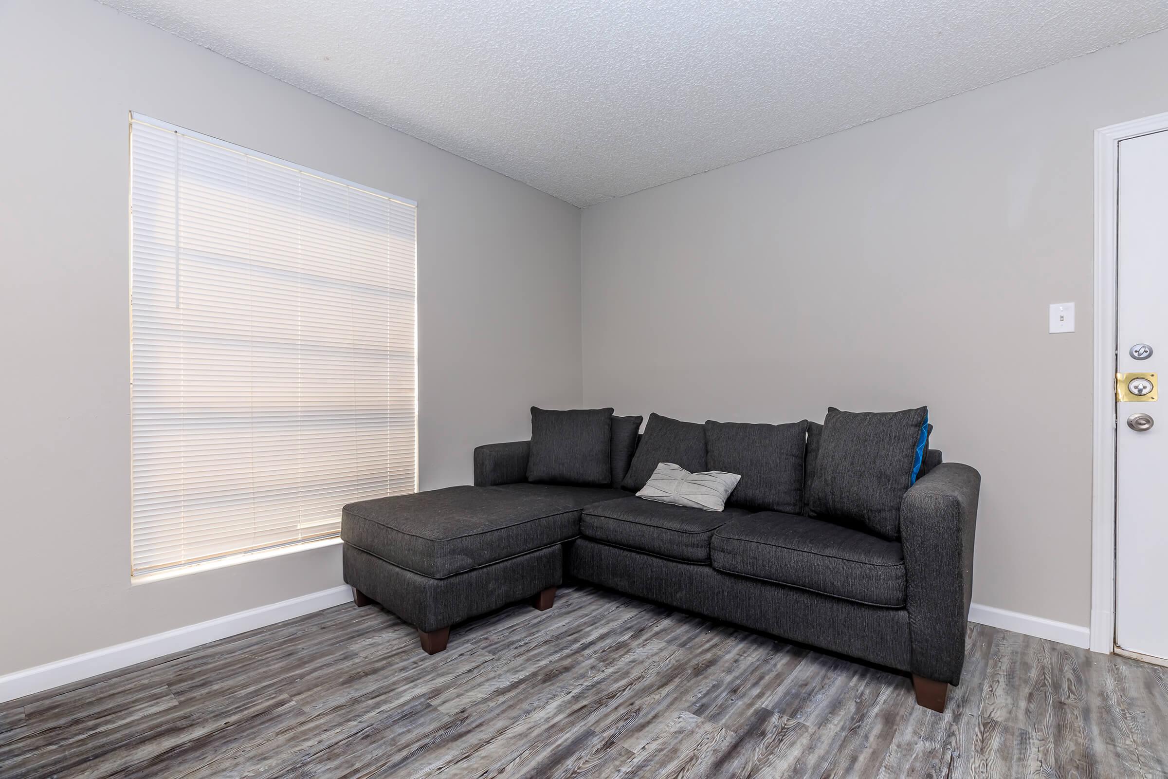 a living room filled with furniture and a large window
