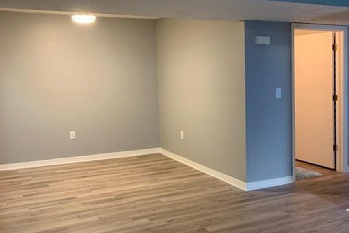 a large empty room with a wooden floor