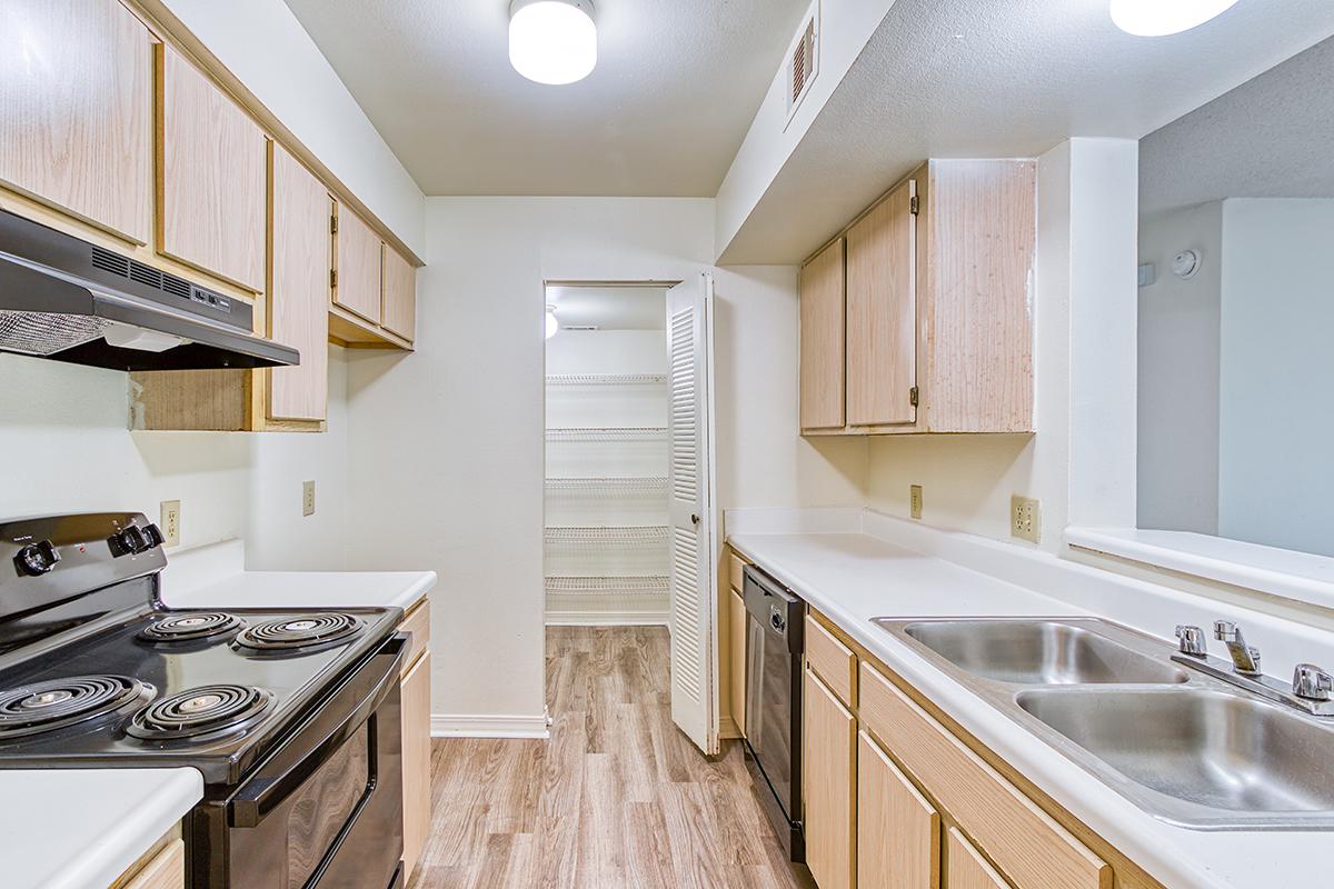 a kitchen with a stove and a sink