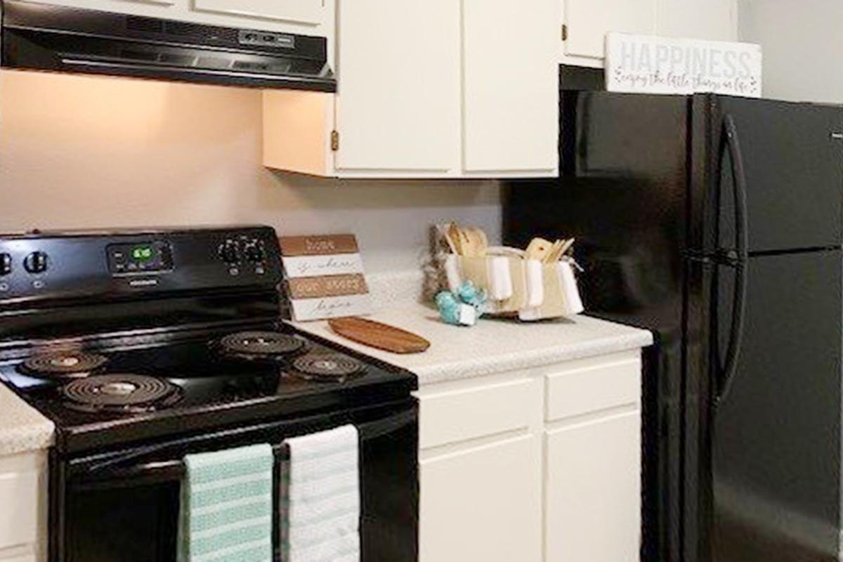 a stove top oven sitting inside of a kitchen