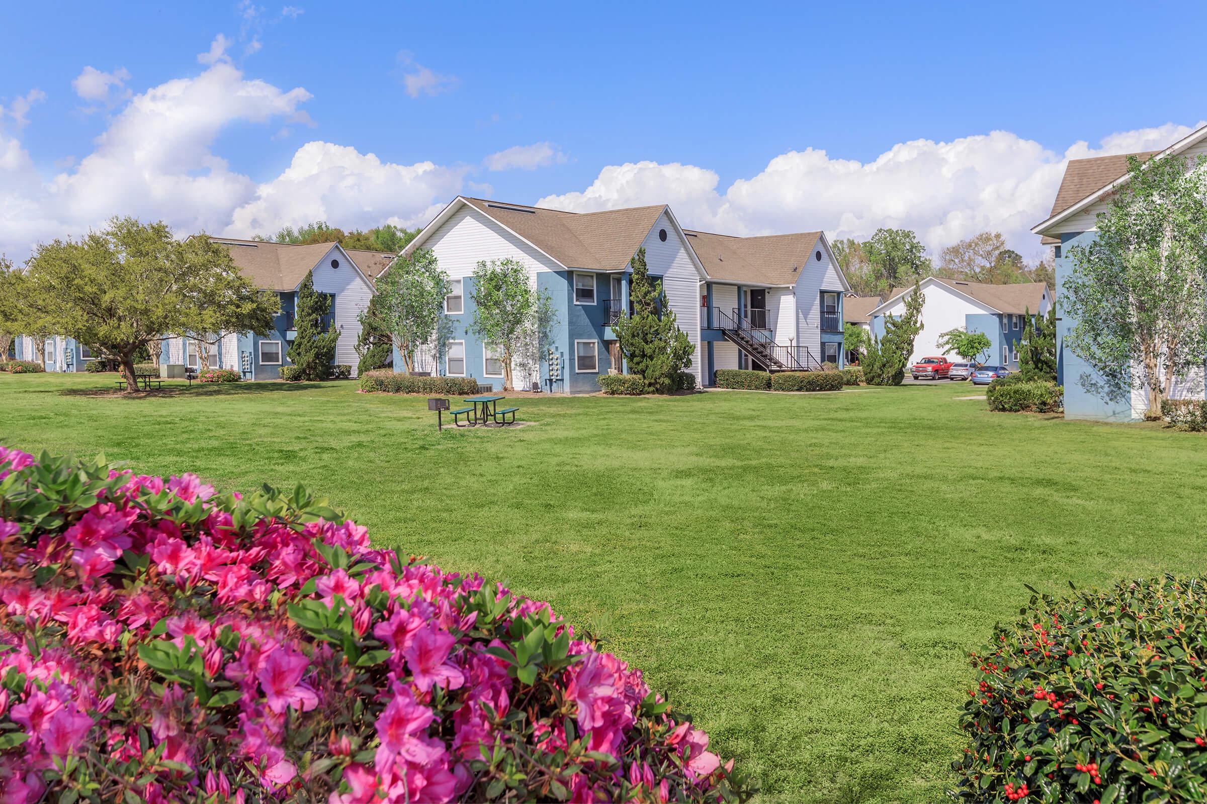 a colorful flower garden in front of a house