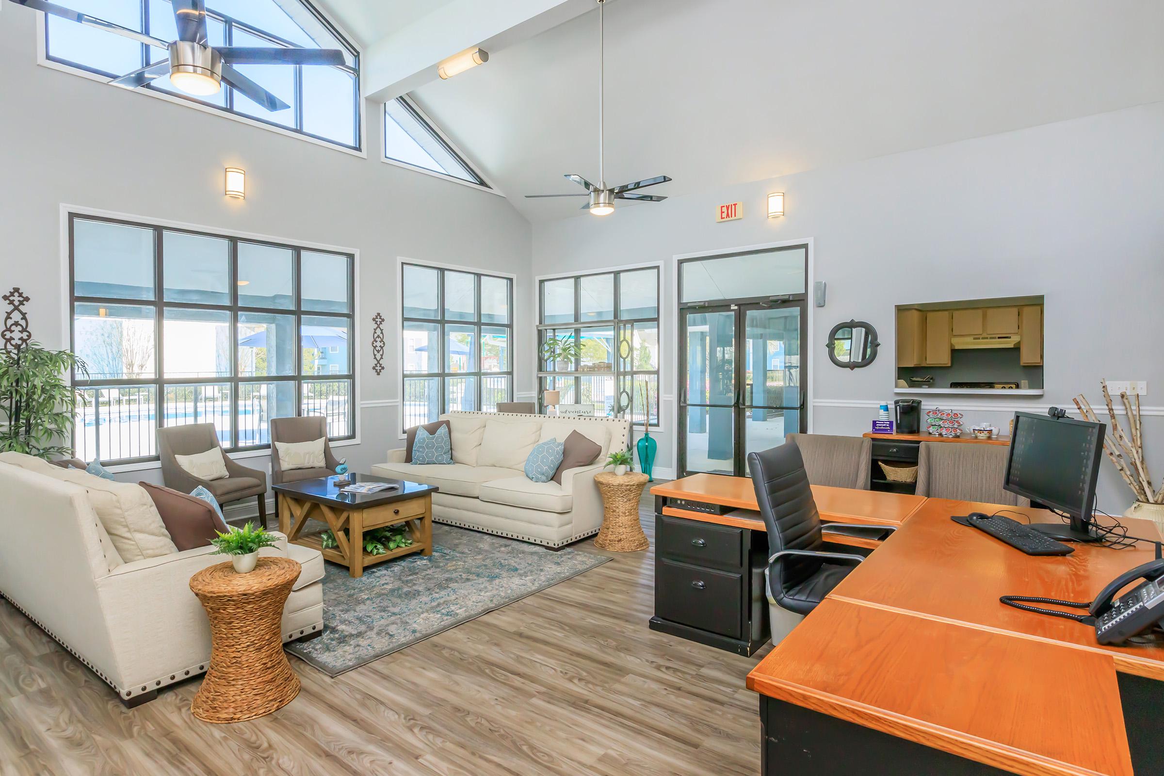 a living room filled with furniture and a large window