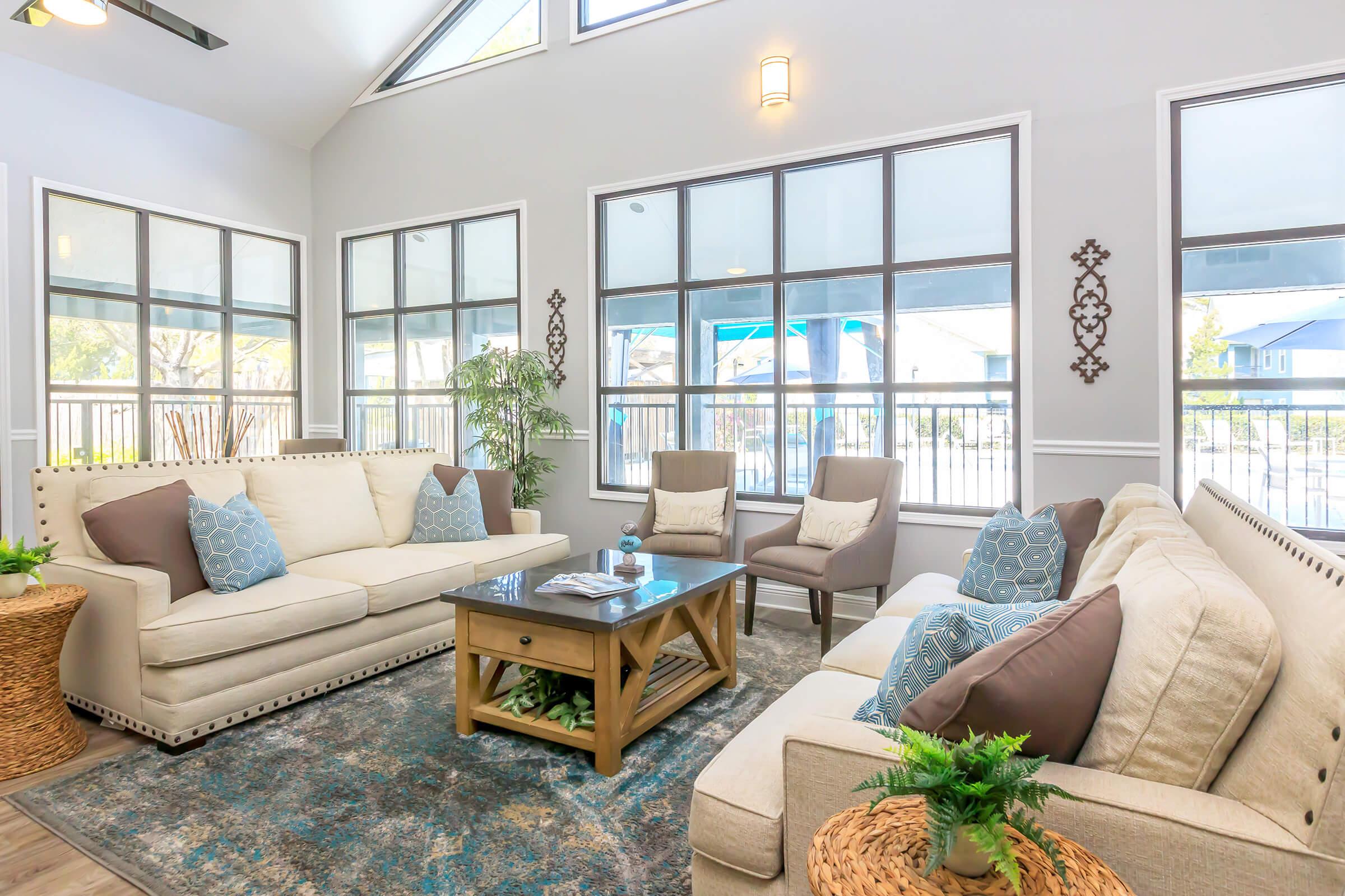 a living room filled with furniture and a large window