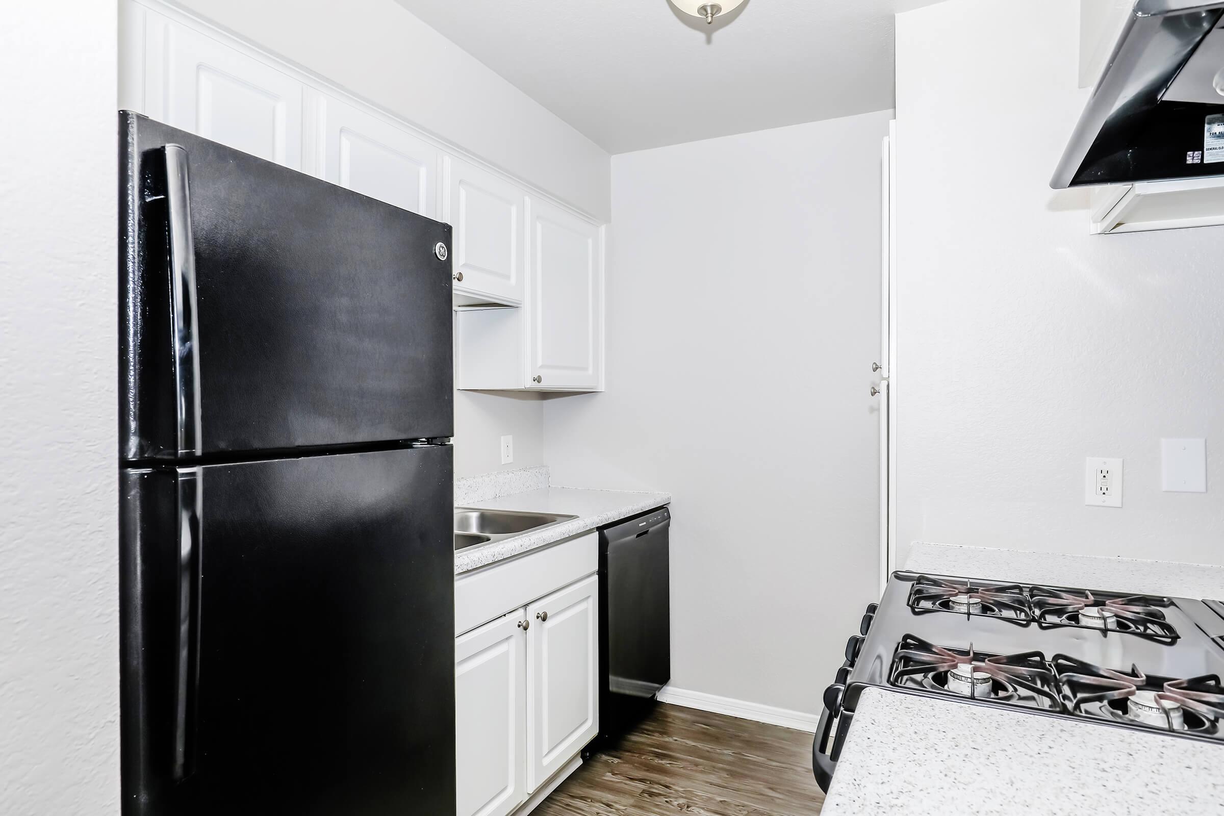 a kitchen with a stove and a refrigerator