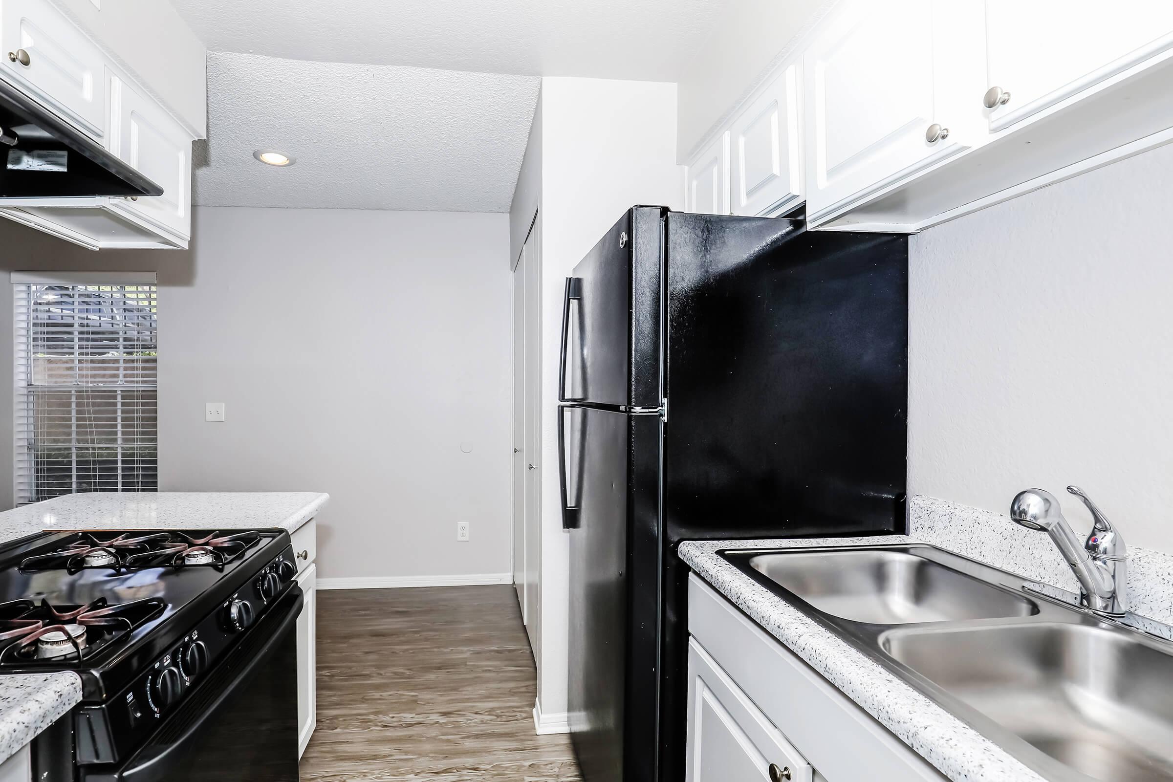 a stove top oven sitting inside of a kitchen