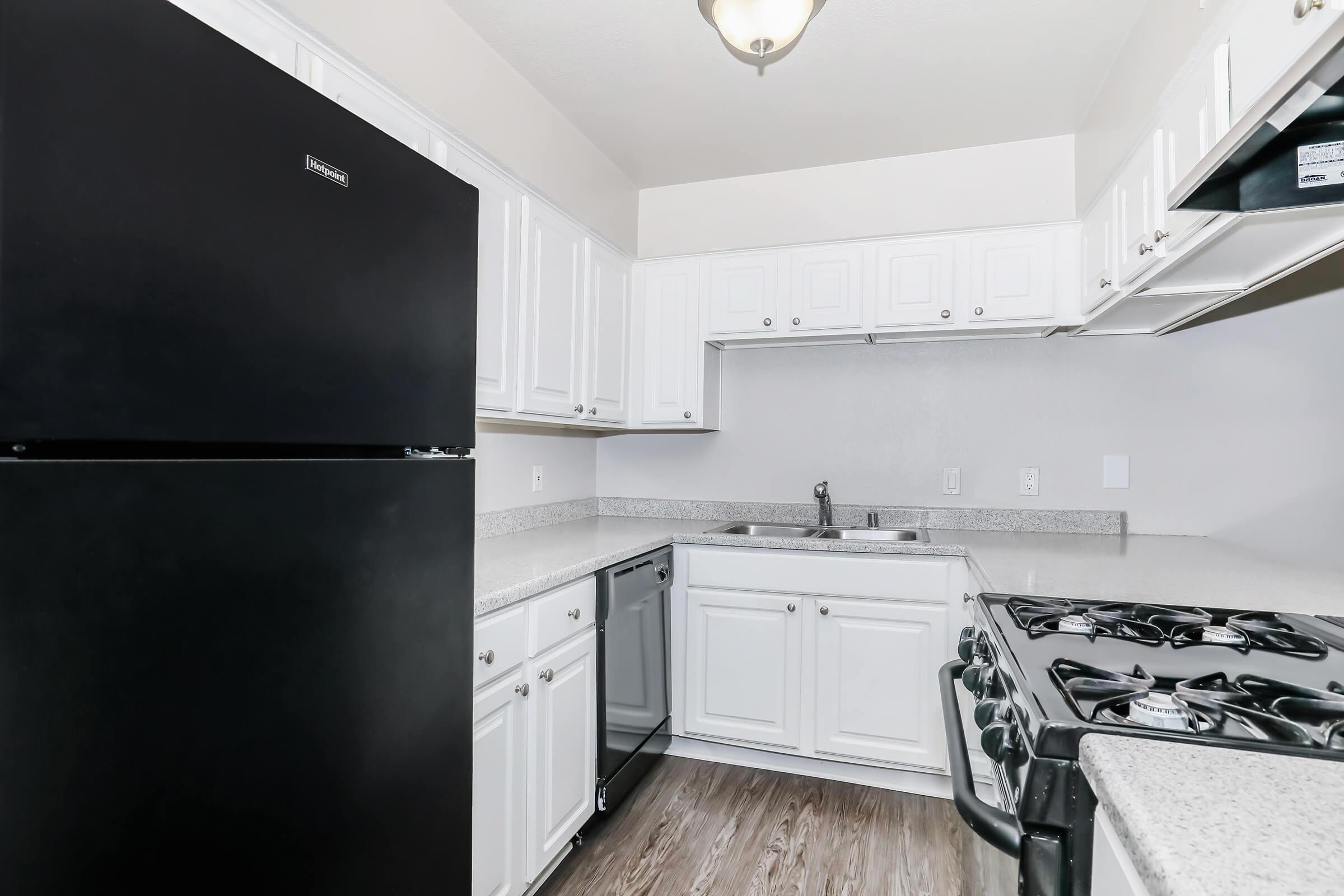 a kitchen with a stove and a refrigerator