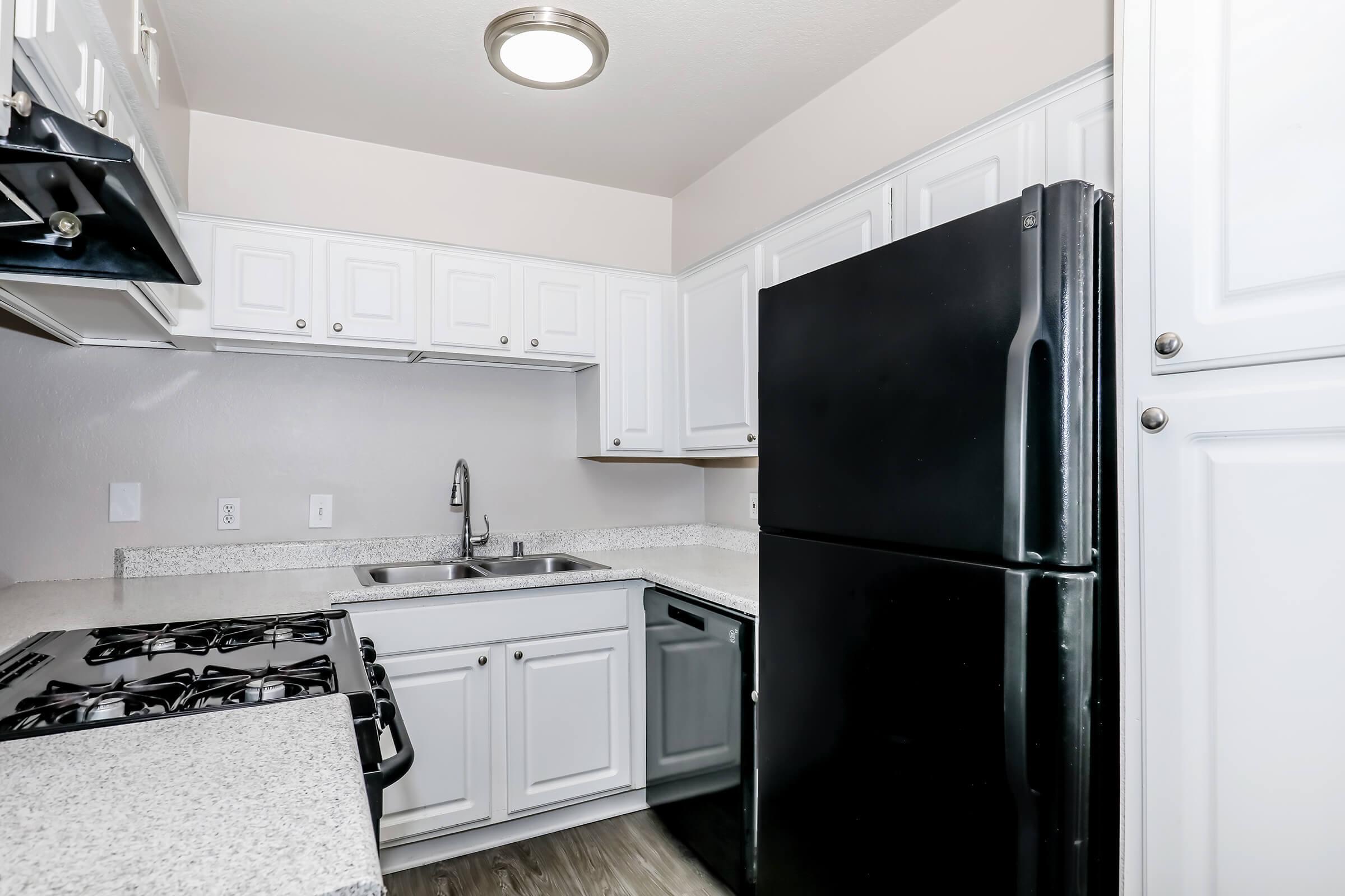 a kitchen with a stove and a refrigerator