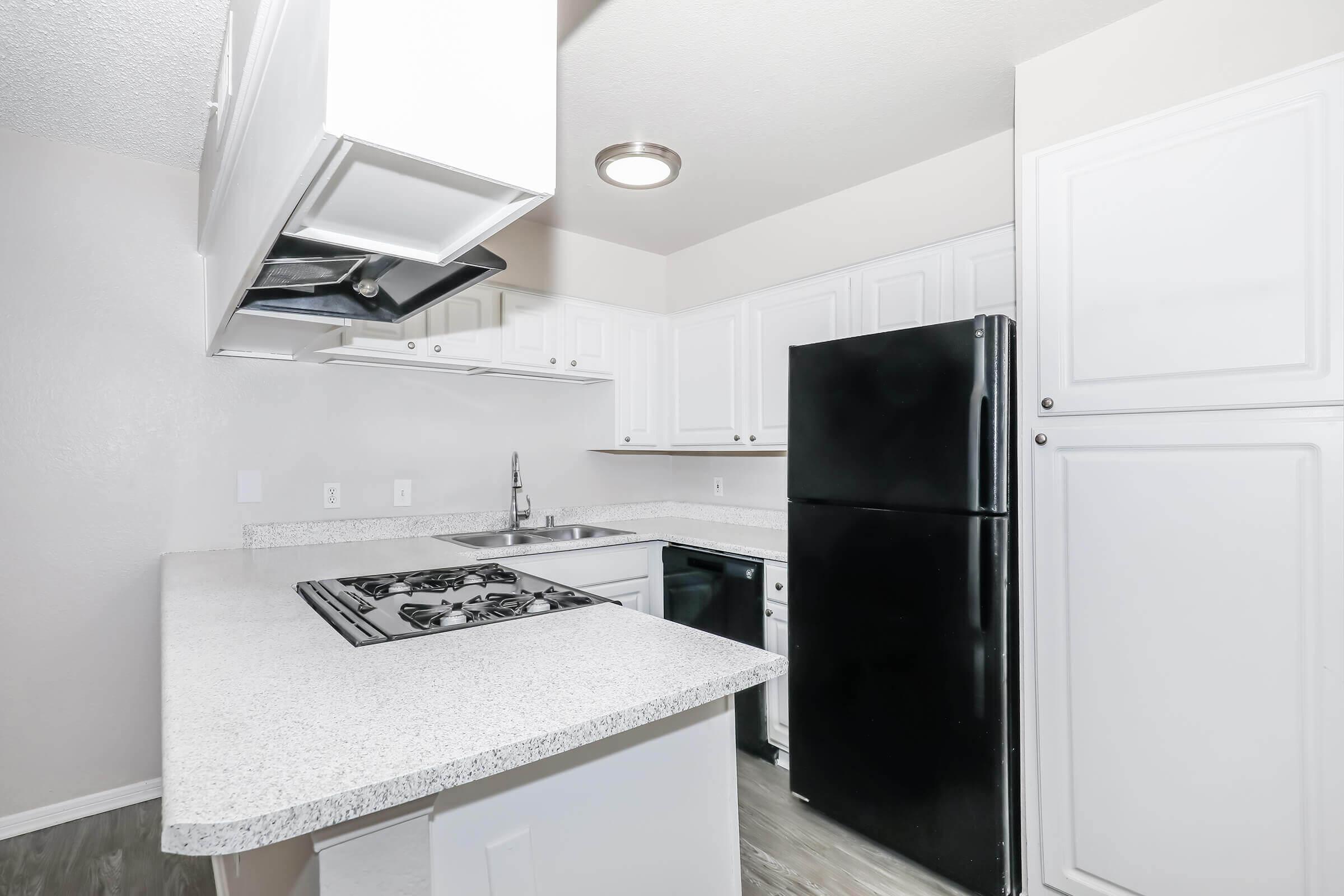 a kitchen with a stove and a refrigerator