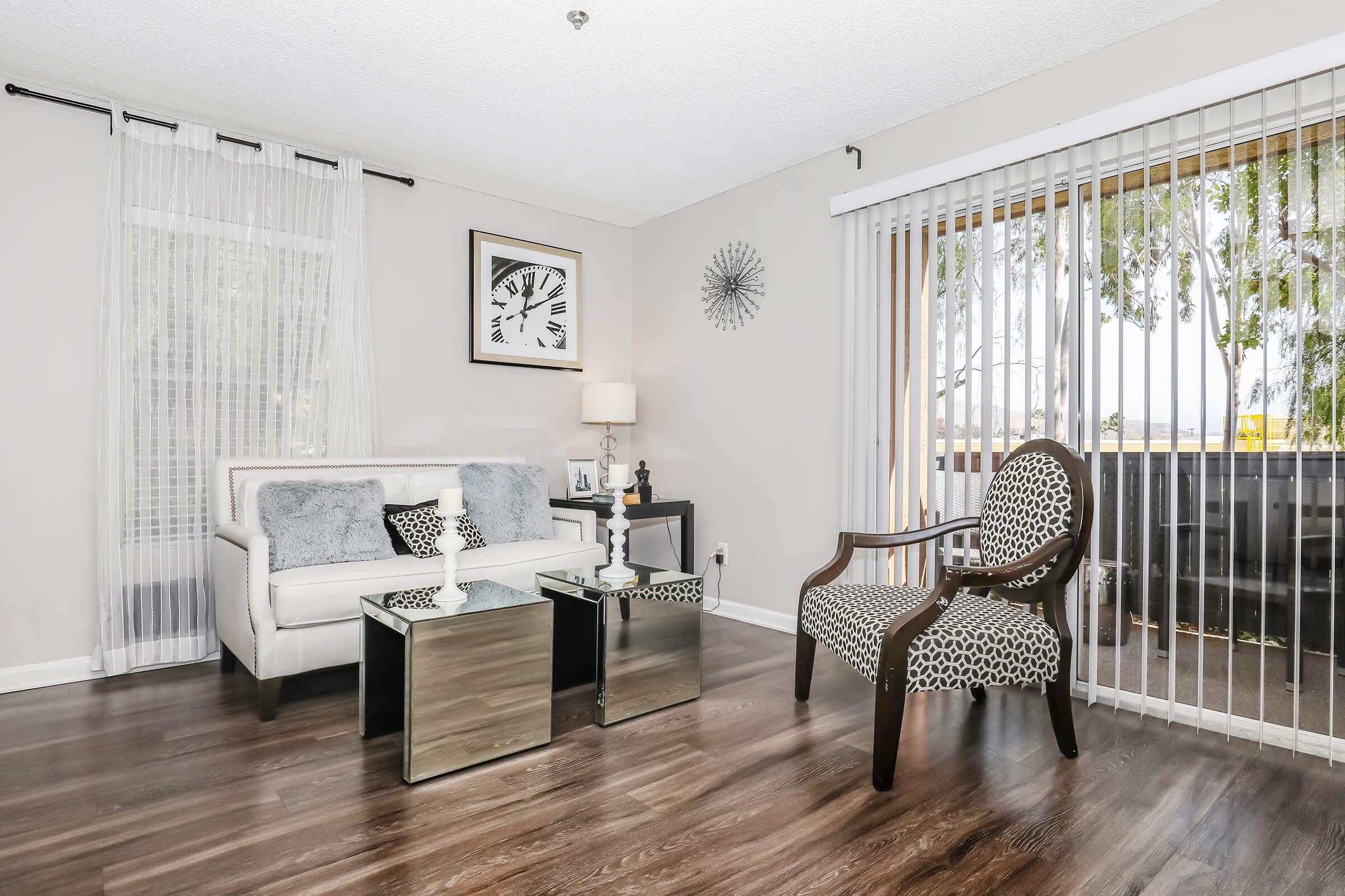 a living room filled with furniture and a large window