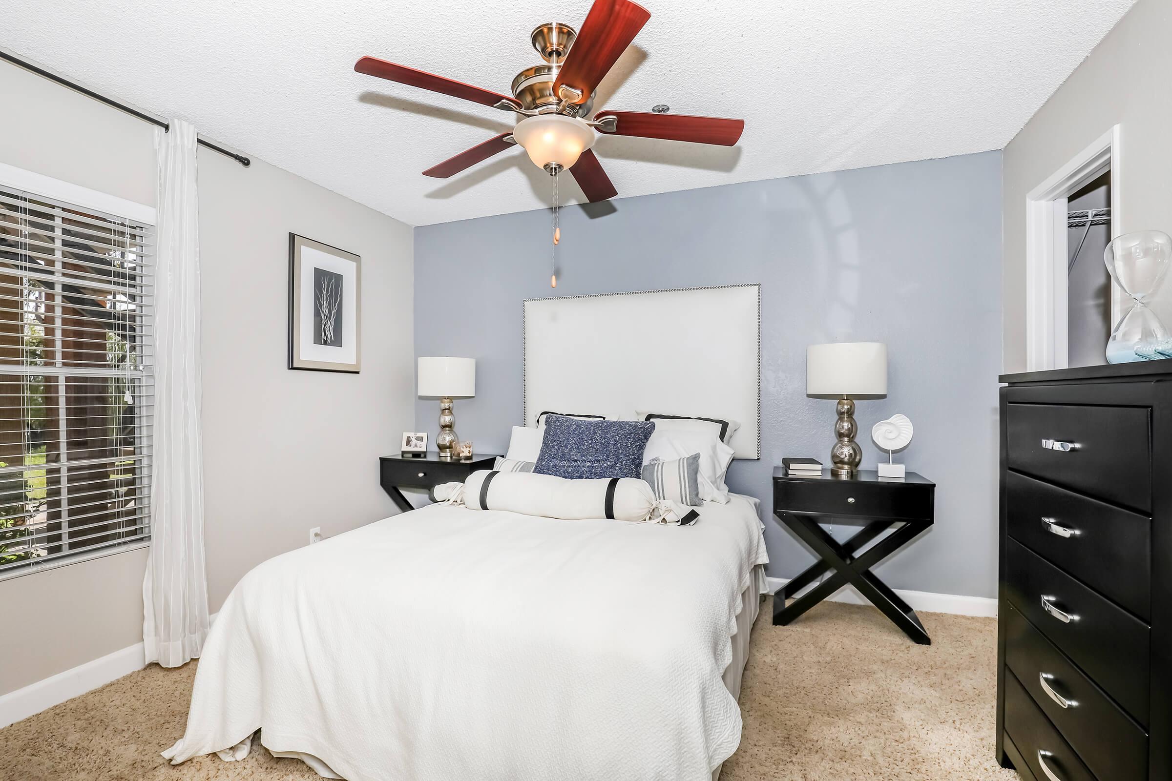 a bedroom with a bed and desk in a room