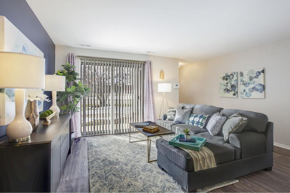 a living room filled with furniture and a large window