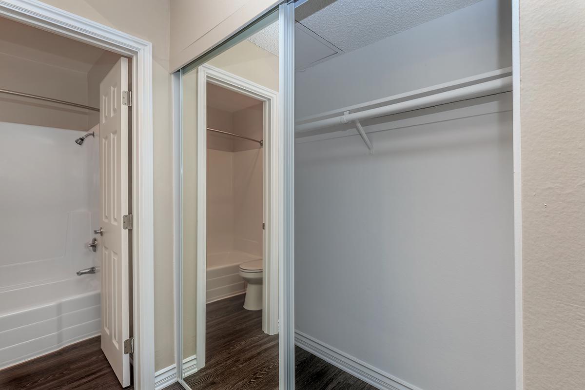 Hallway closet with sliding mirror glass doors