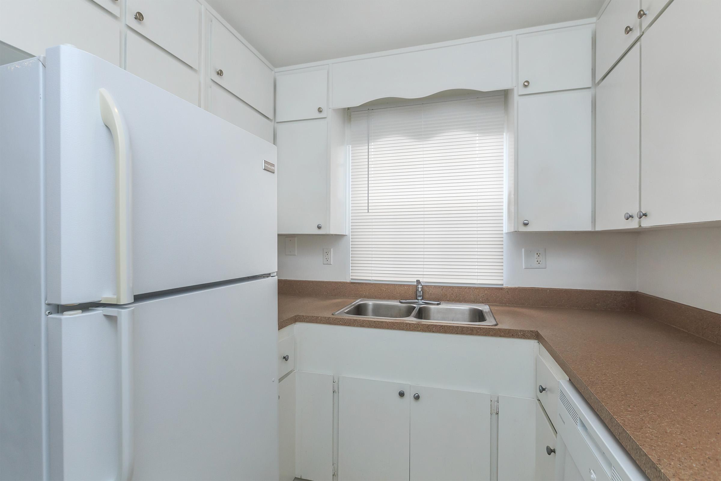 a white refrigerator freezer sitting inside of a kitchen