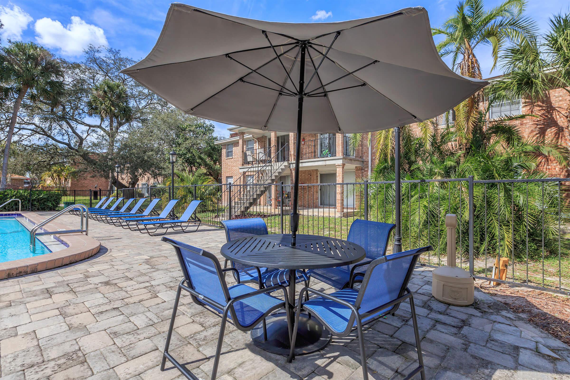 a table topped with a blue umbrella