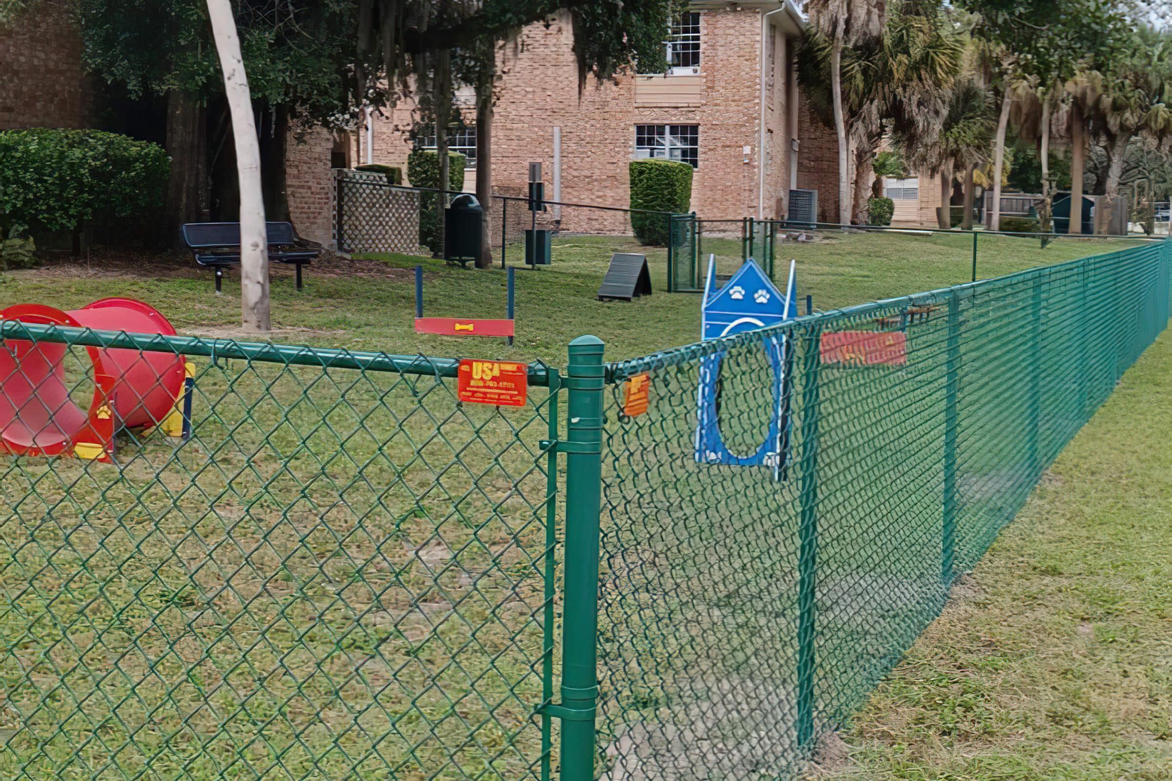 a group of lawn chairs sitting on top of a green fence