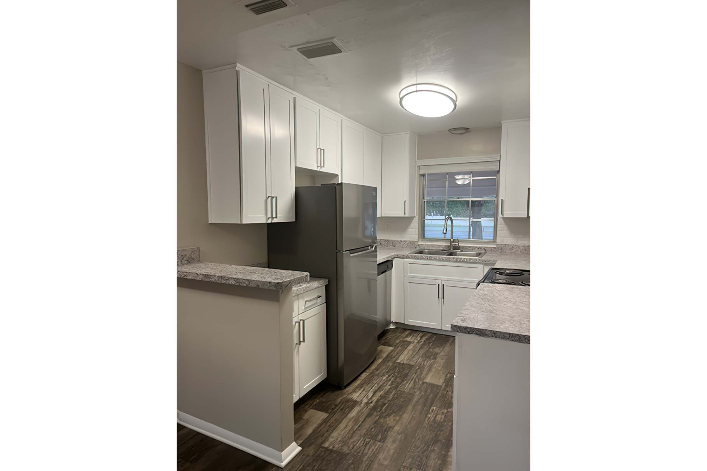 a kitchen with a sink and a refrigerator