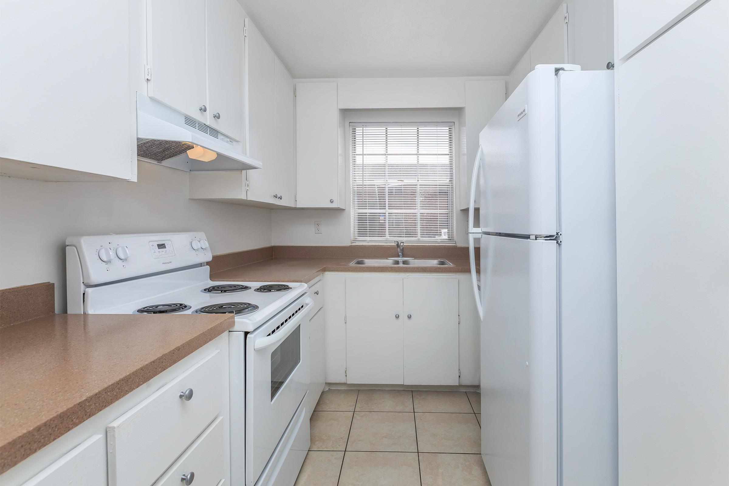 a stove top oven sitting inside of a kitchen