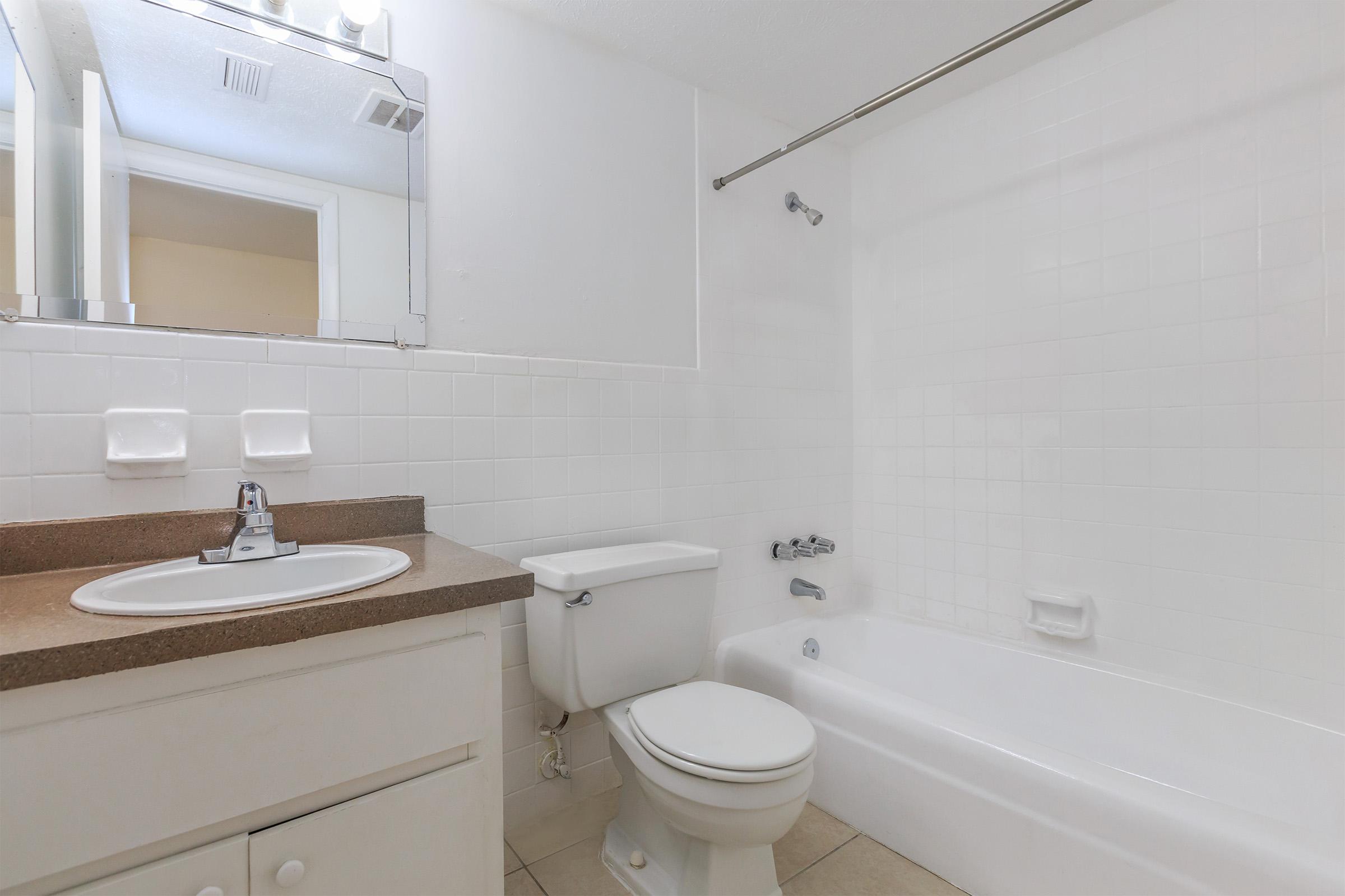 a large white tub sitting next to a sink