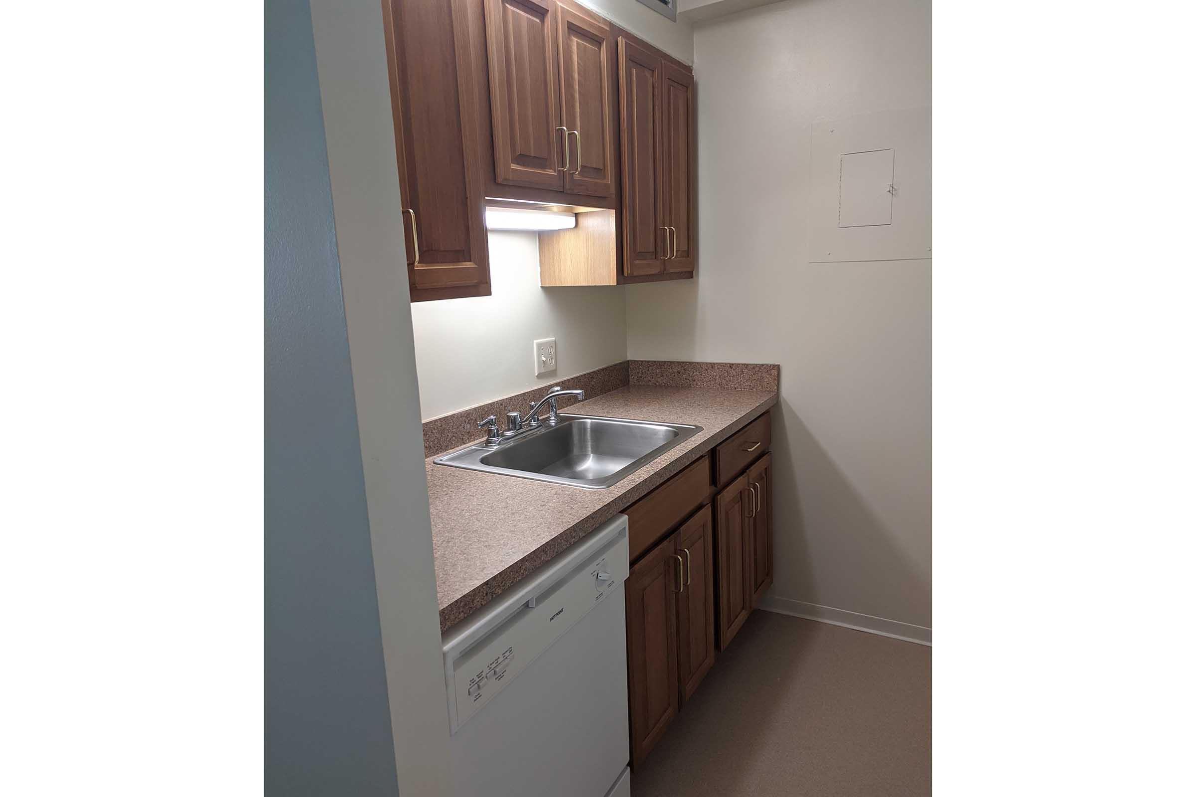 a kitchen with a sink and a refrigerator