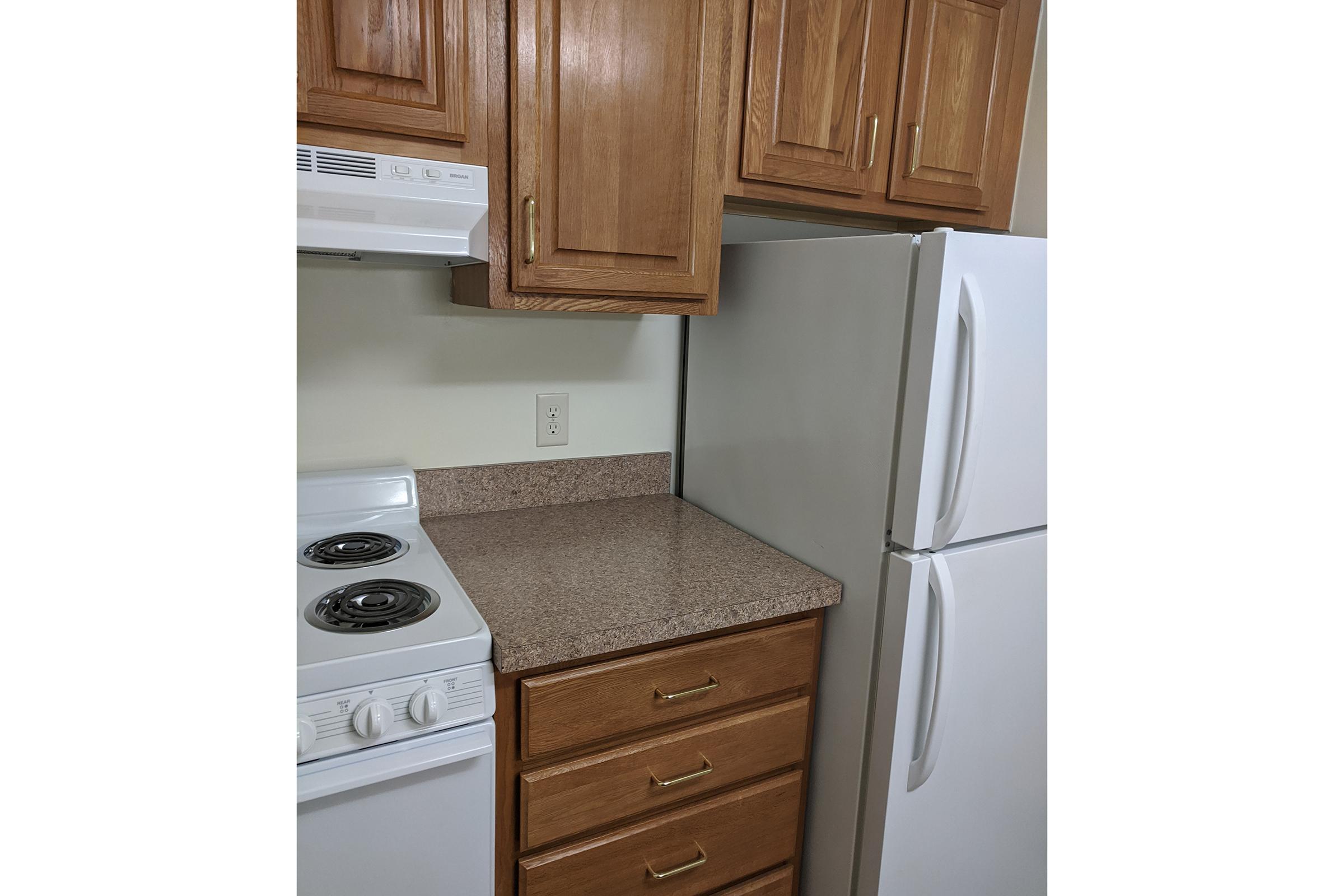 a kitchen with a stove top oven sitting inside of a refrigerator