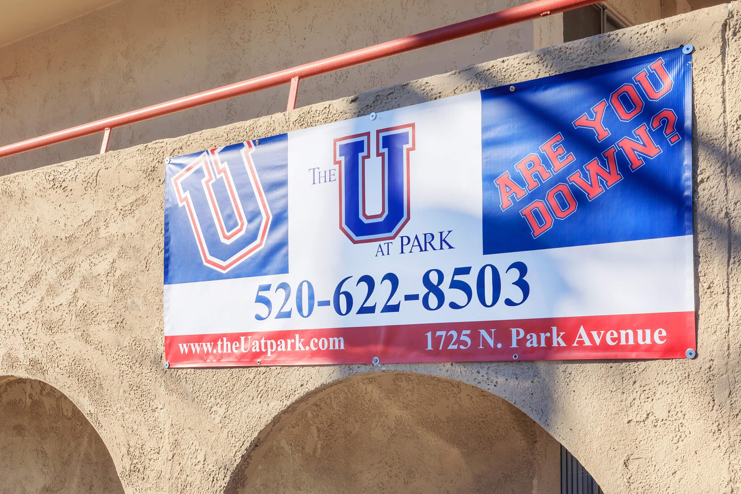 Banner advertising "The U at Park" with text reading "Are you down?" and contact information: phone number 520-622-8503 and address: 1725 N. Park Avenue. The design features bold, colorful lettering on a light-colored background.