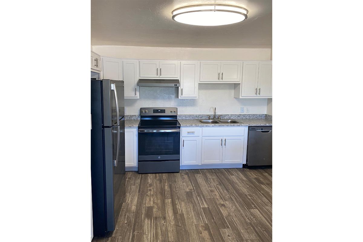 a stove top oven sitting inside of a kitchen