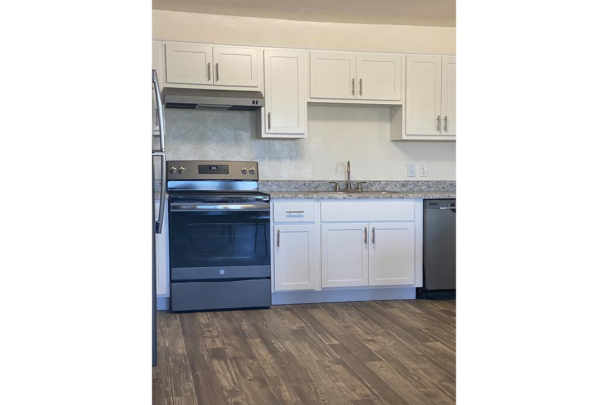 a kitchen with a stove and a refrigerator