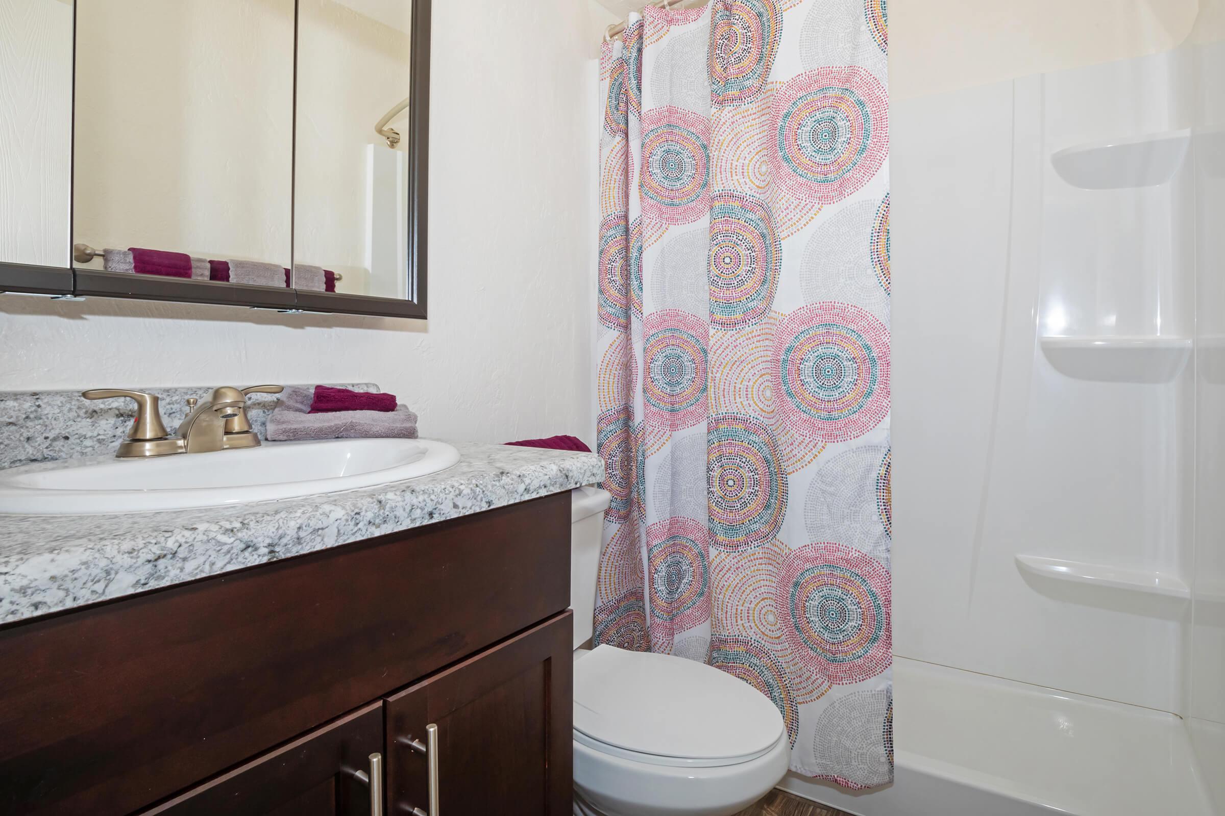 a white sink sitting next to a shower