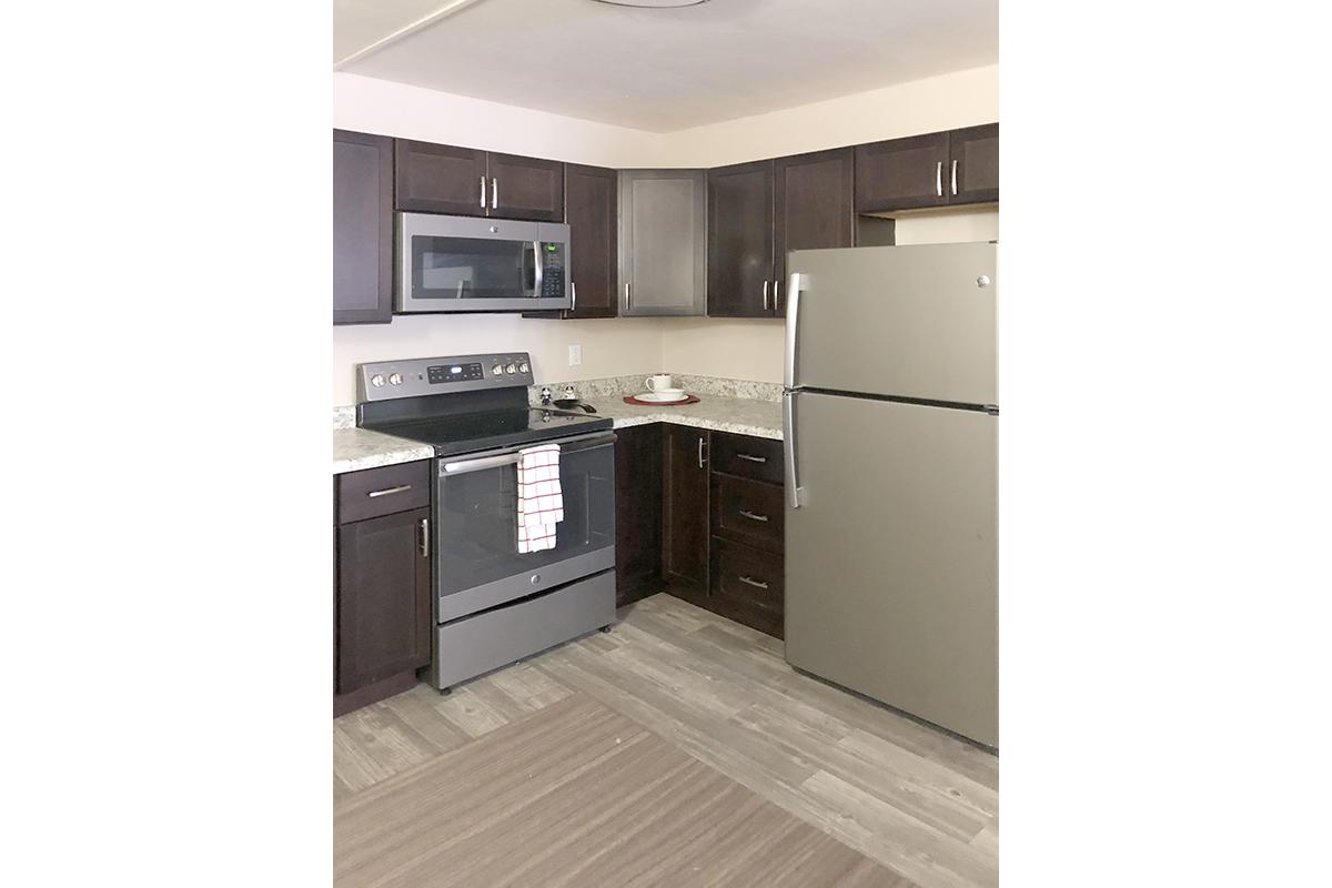 a kitchen with stainless steel appliances and wooden cabinets