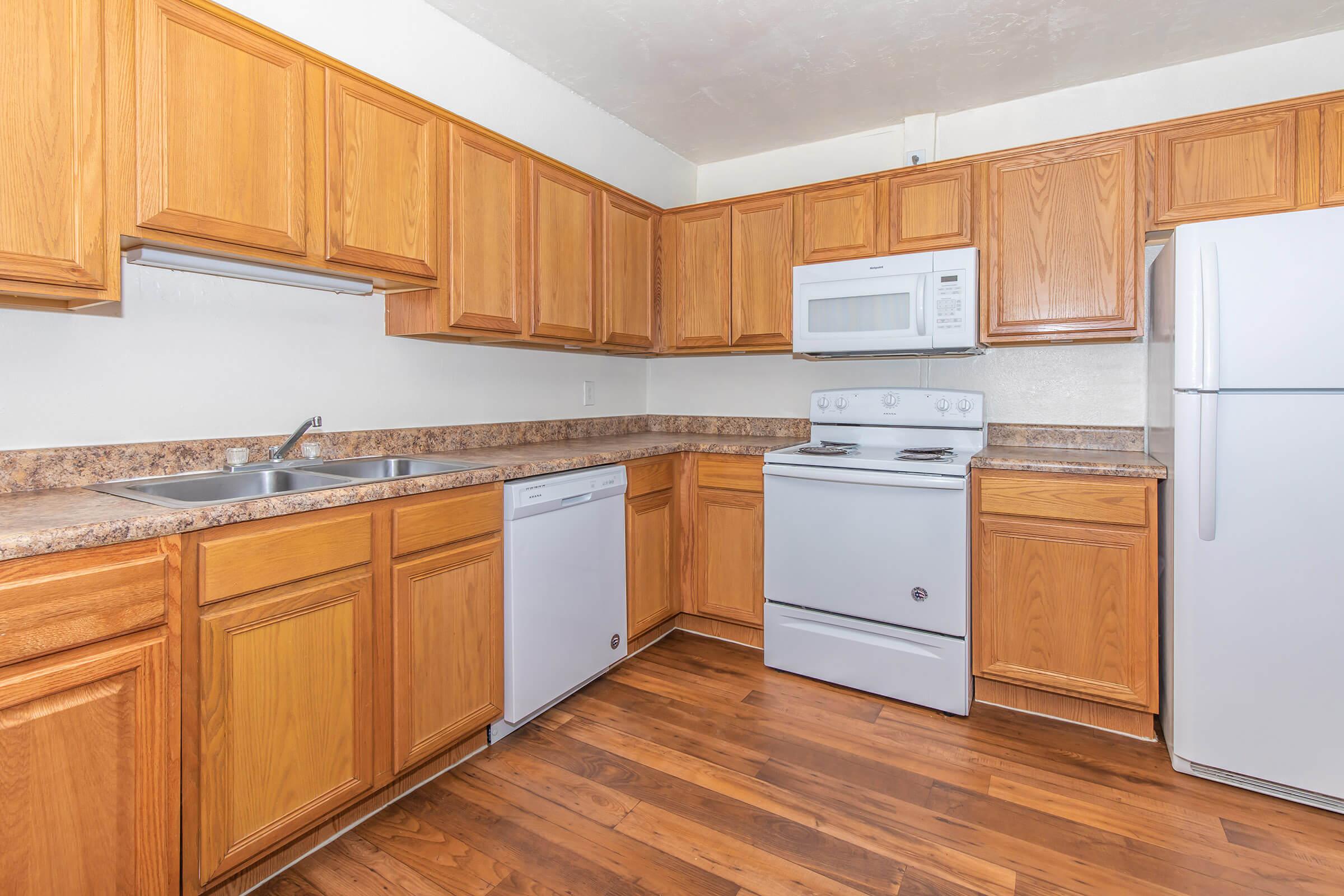 a kitchen with wooden cabinets and a refrigerator