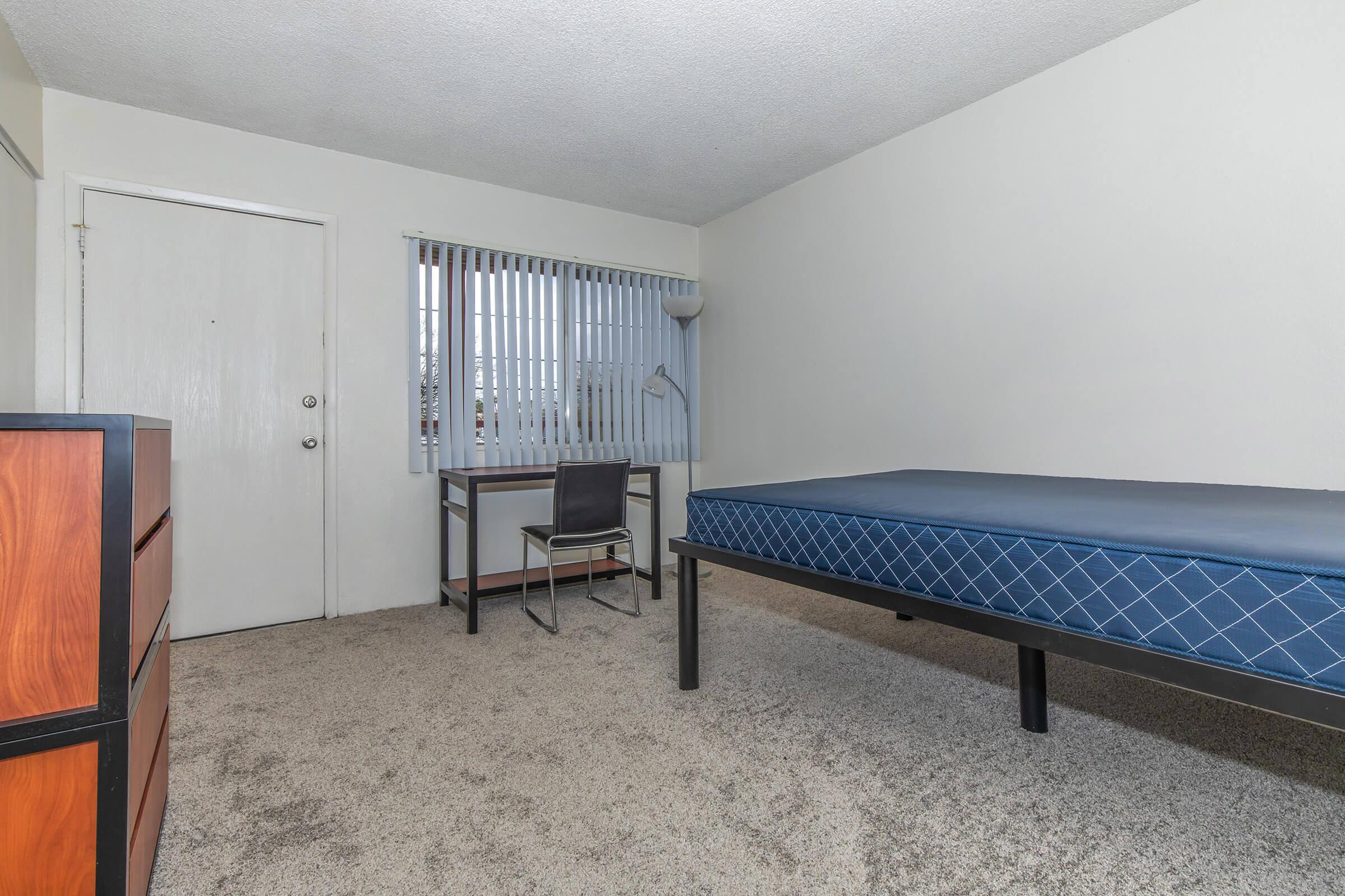 a bedroom with a wooden floor