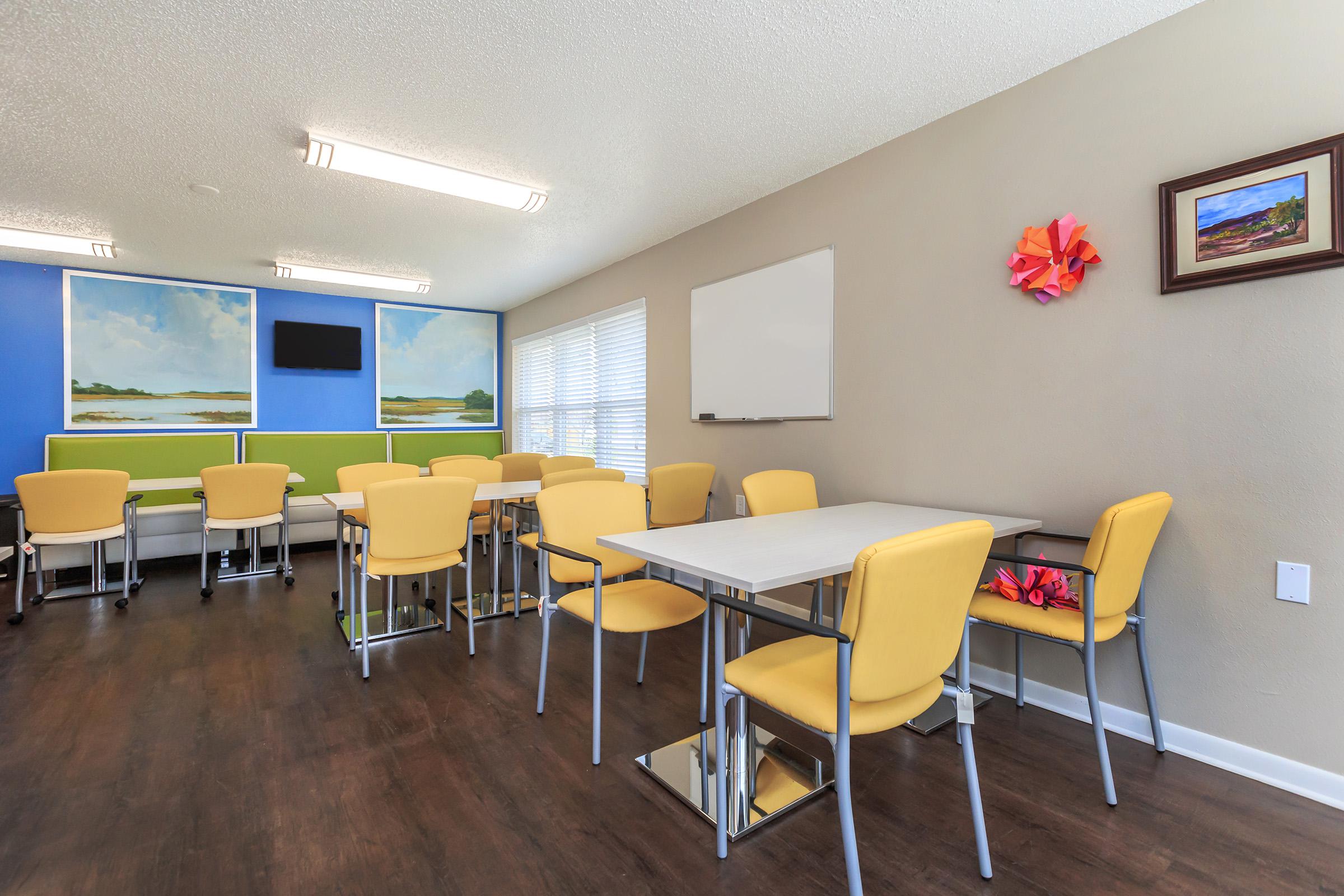 an office with a desk and chair in a room