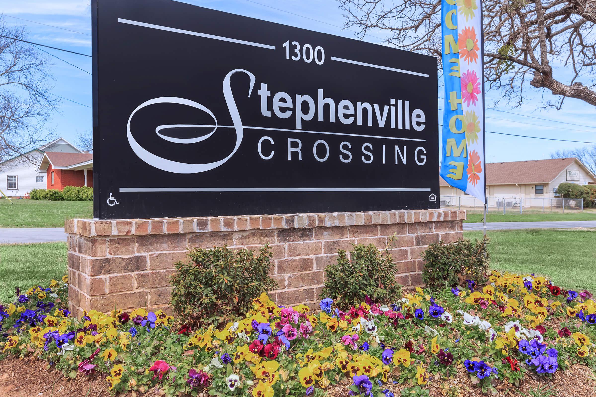 a close up of a flower garden in front of a building