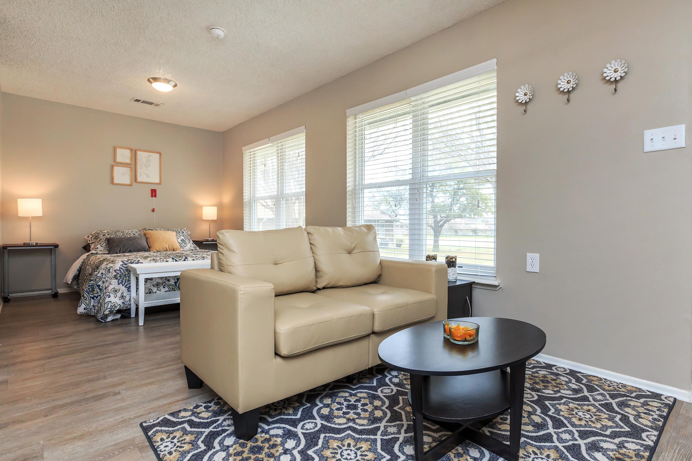 a living room filled with furniture and a flat screen tv